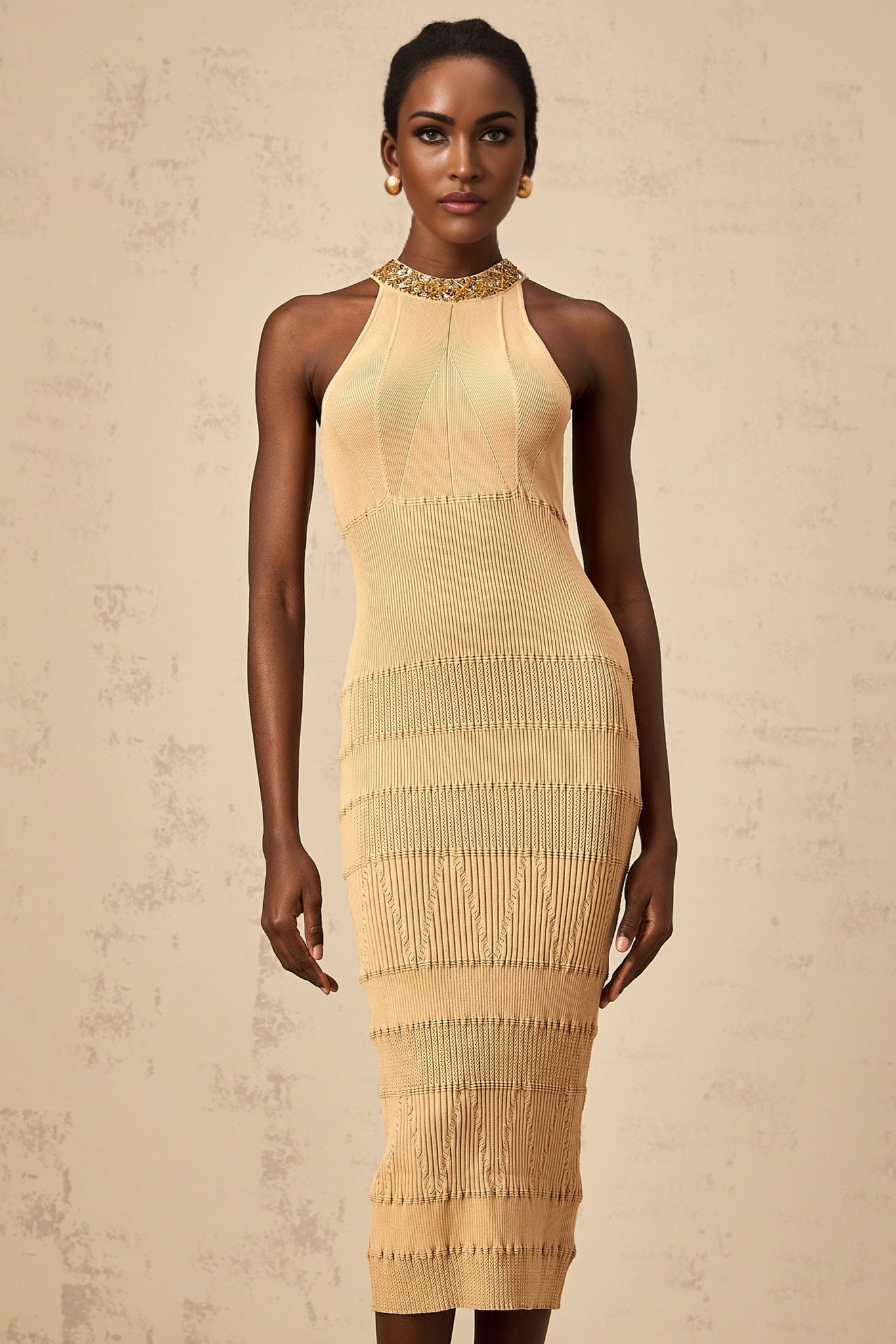 Woman wearing a shimmering kneelength dress with long sleeves and ribbed texture