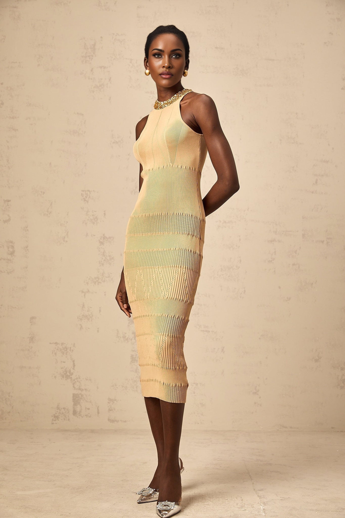 Woman wearing a shimmering midi dress with sequins and ribbed texture