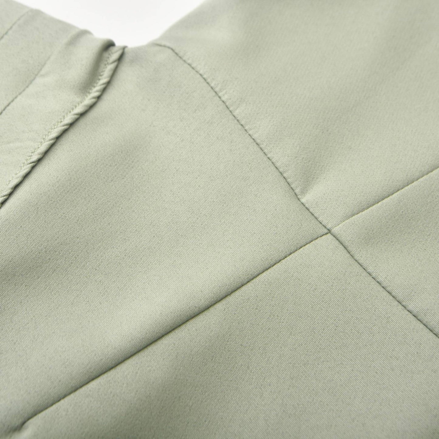 Green halterneck dress with open back pleat detailing and voluminous skirt