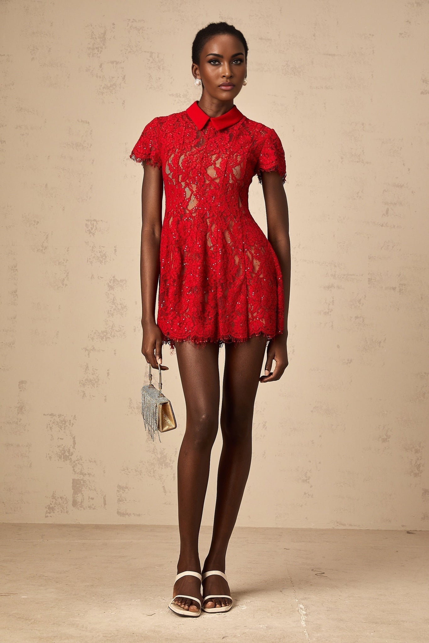 Woman wearing a short red dress with sequins and lace details