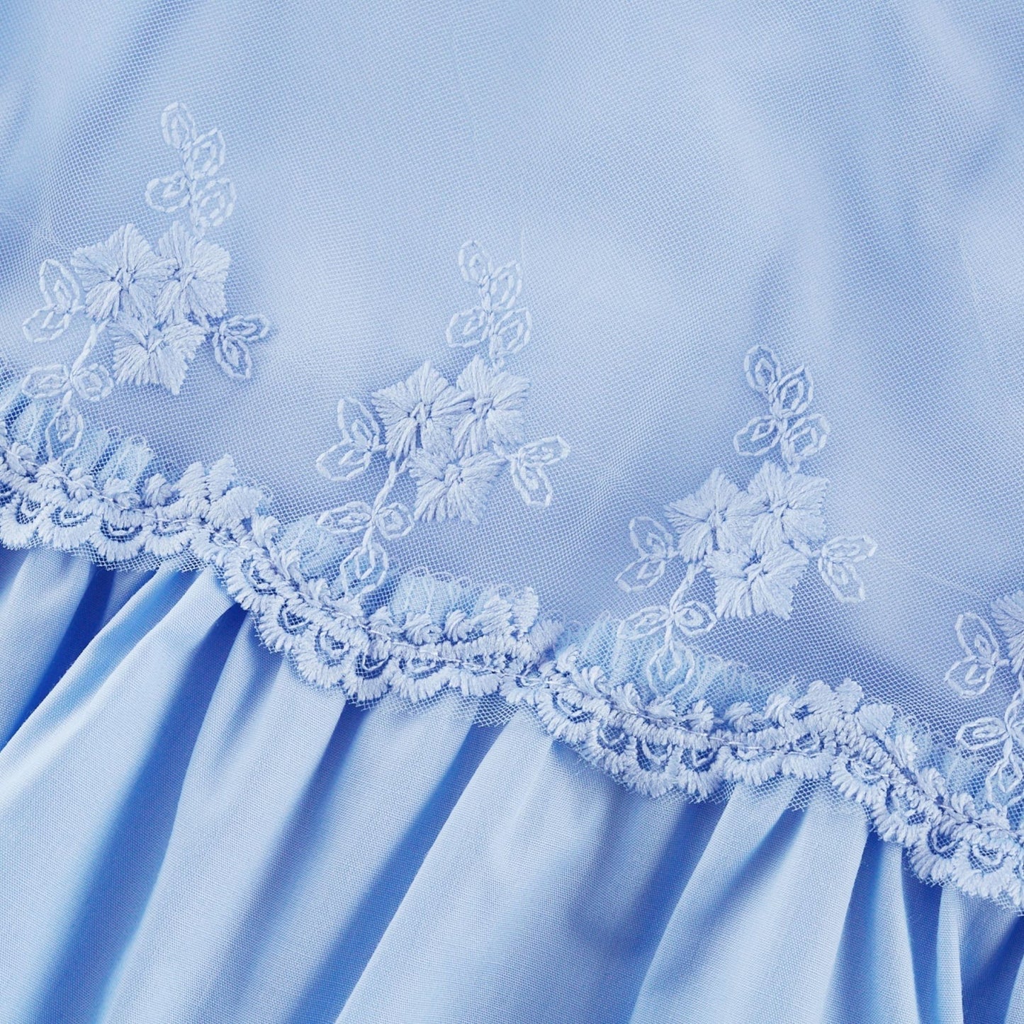 Woman wearing a shoulderfree tiered midi dress in light fabric with flowy silhouette and feminine design