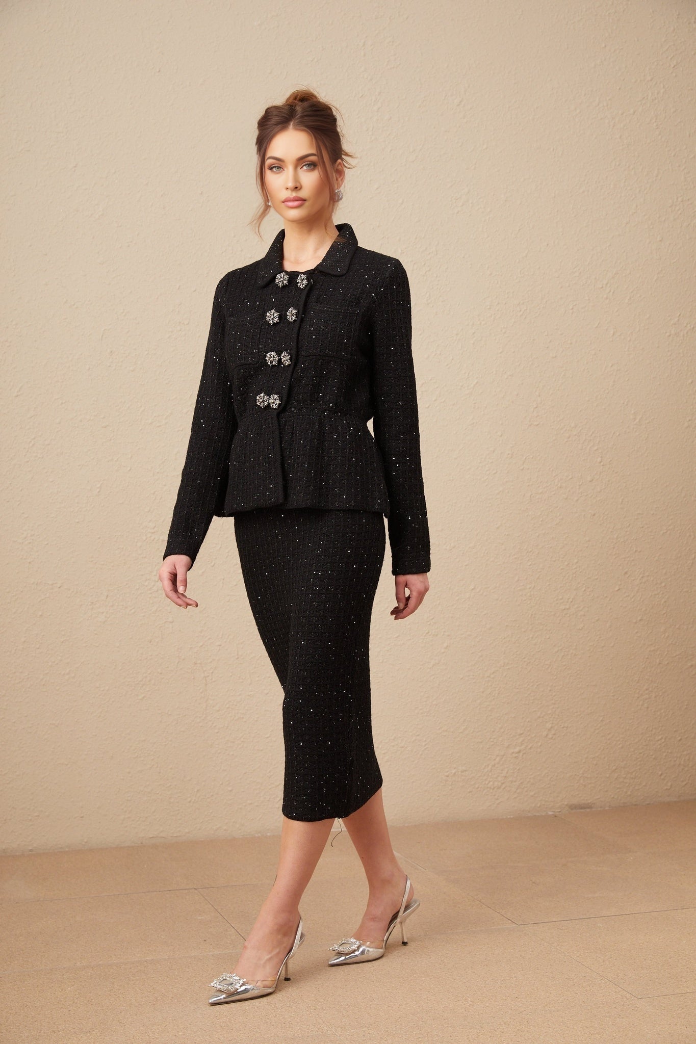 Woman wearing a sparkly sequined matching set consisting of a waffle knit jacket and skirt in a coordinated style