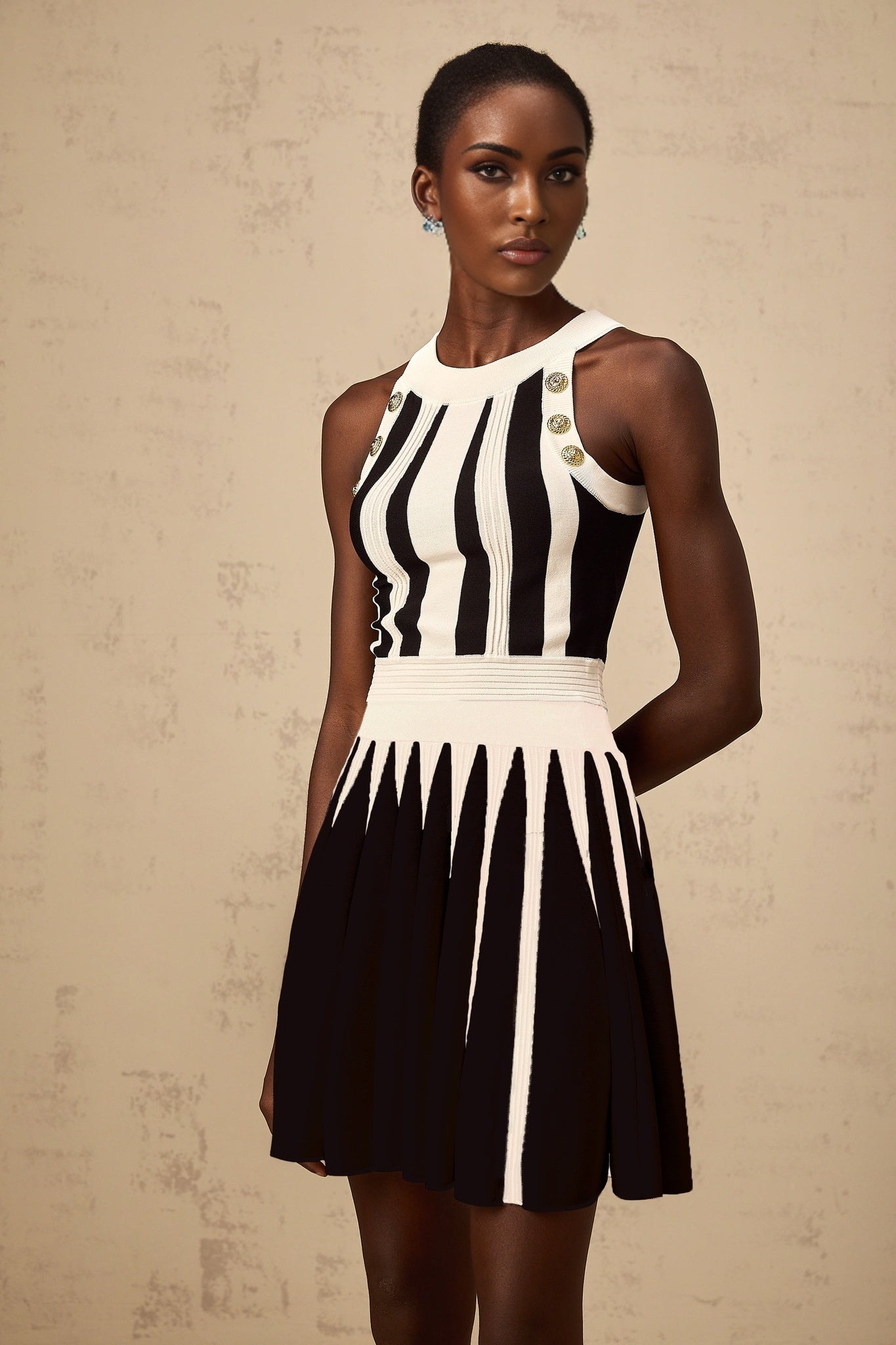 Woman wearing a striped knit top and matching skirt set in contrasting colors named Iseult