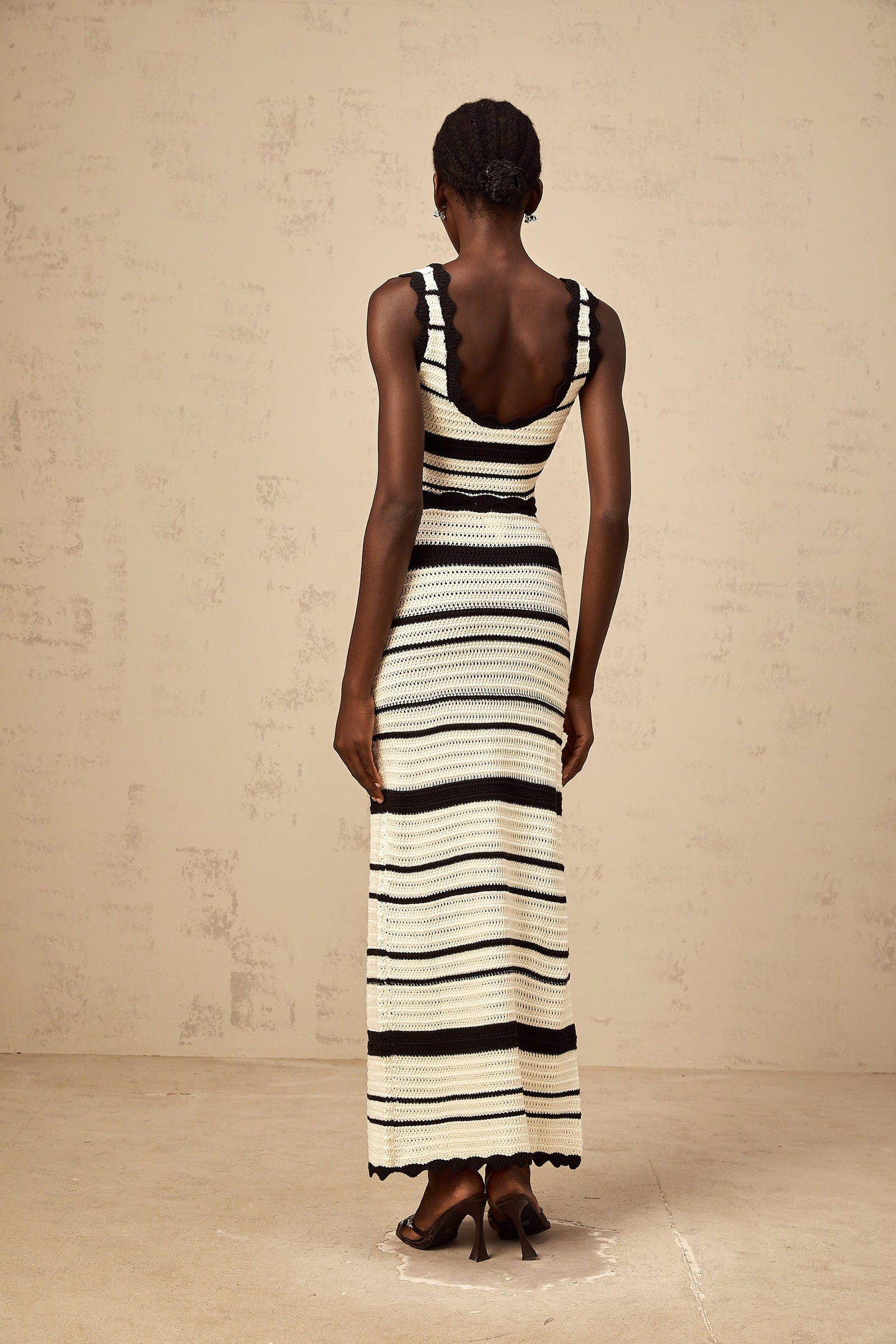 Woman wearing a striped vest top and matching skirt in contrasting colors from the Avril collection