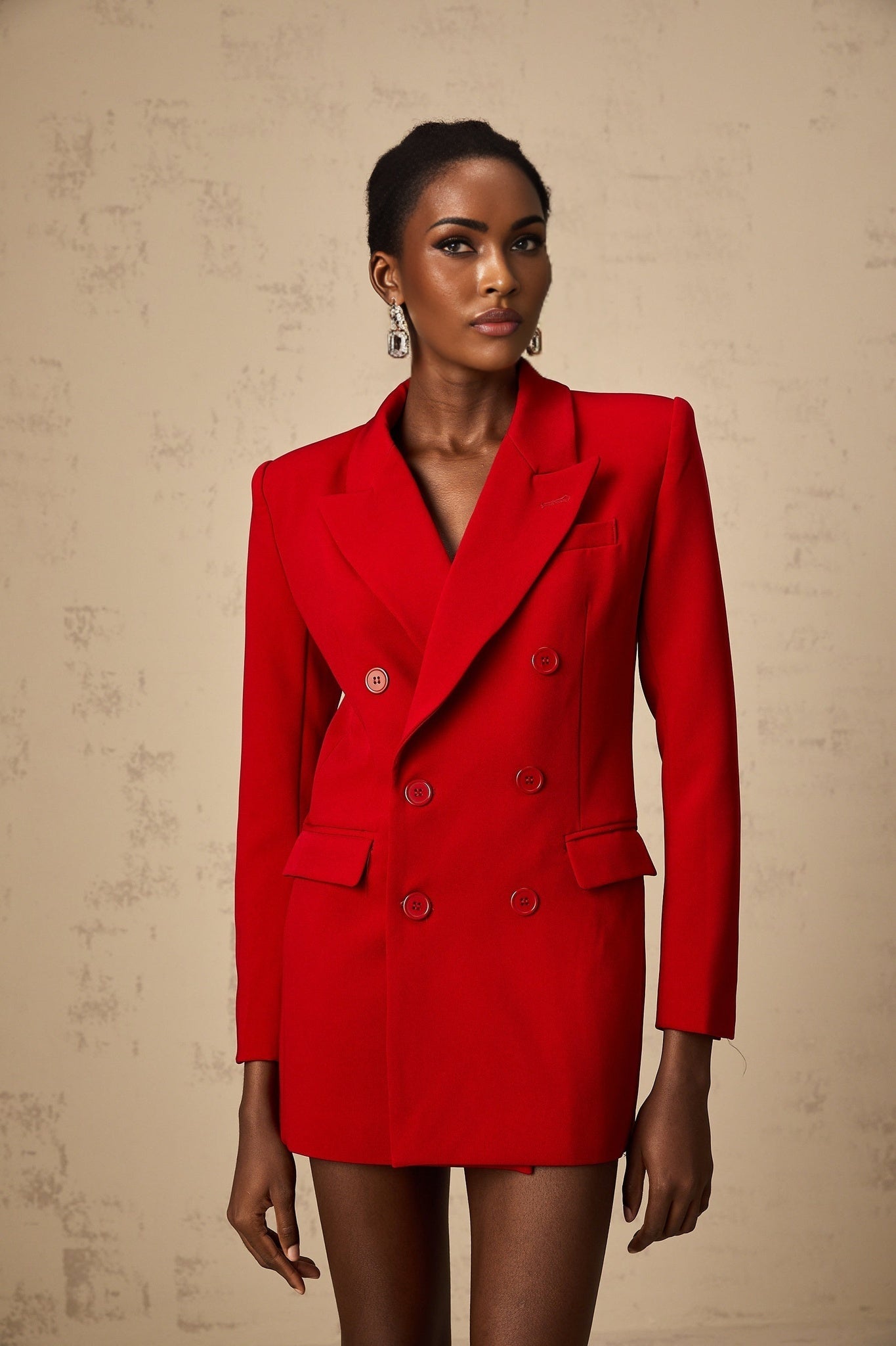Woman wearing a vibrant red doublebreasted blazer with lapels and buttons