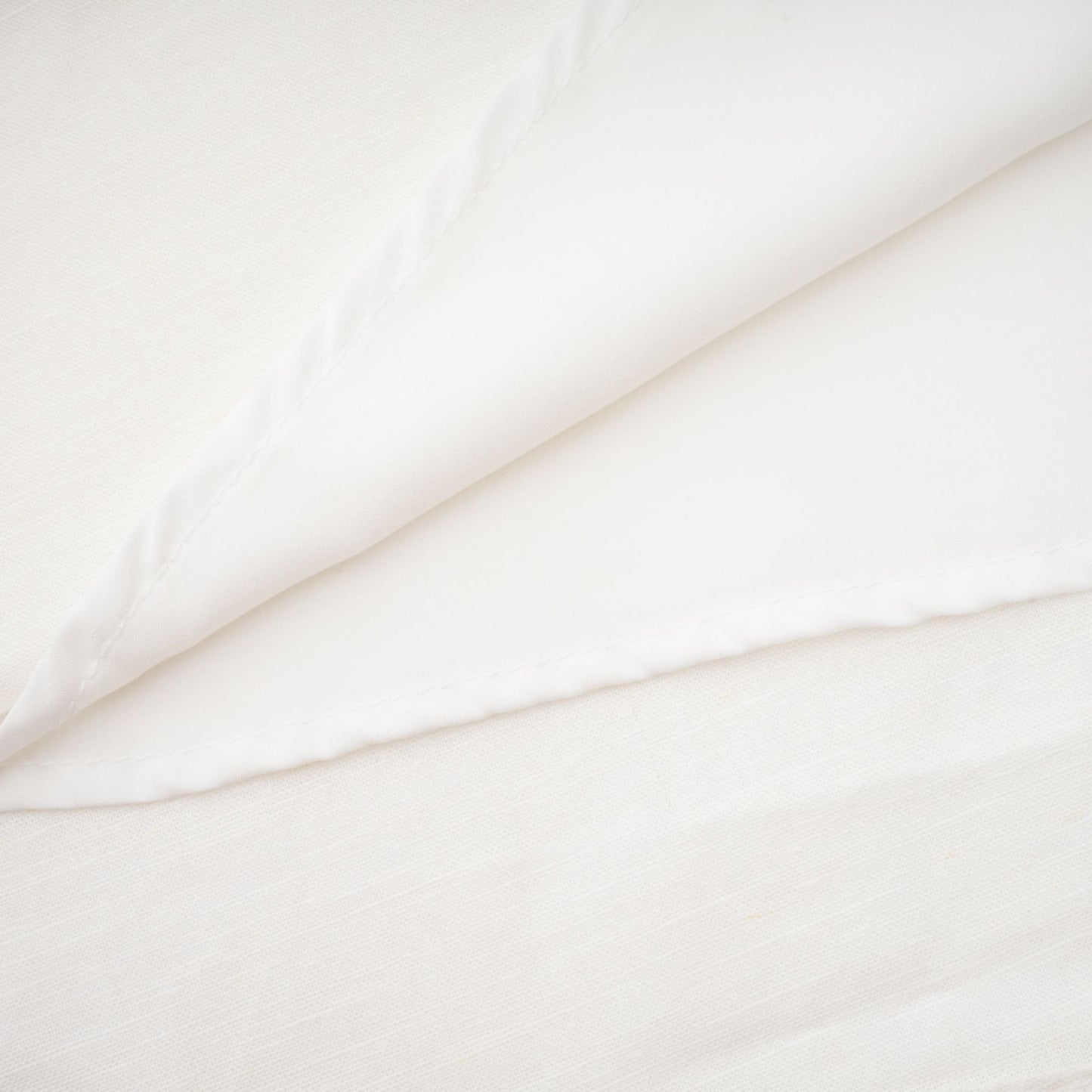 Woman wearing a white corset style midi dress with fitted bodice and flared skirt