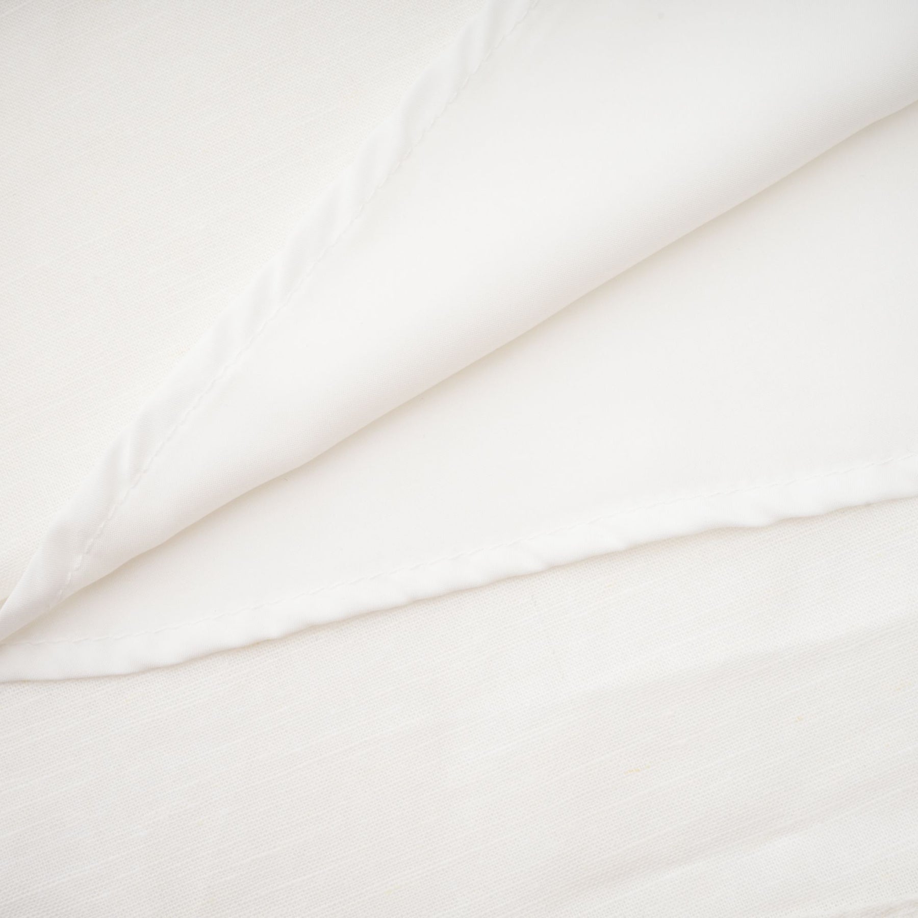 Woman wearing a white corset style midi dress with fitted bodice and flared skirt