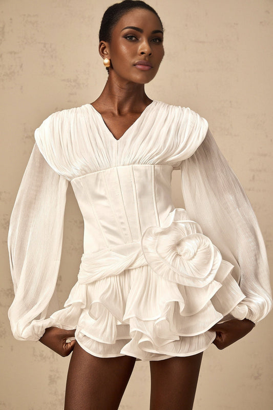 Woman wearing a white mini dress with cinched waist and full pleating