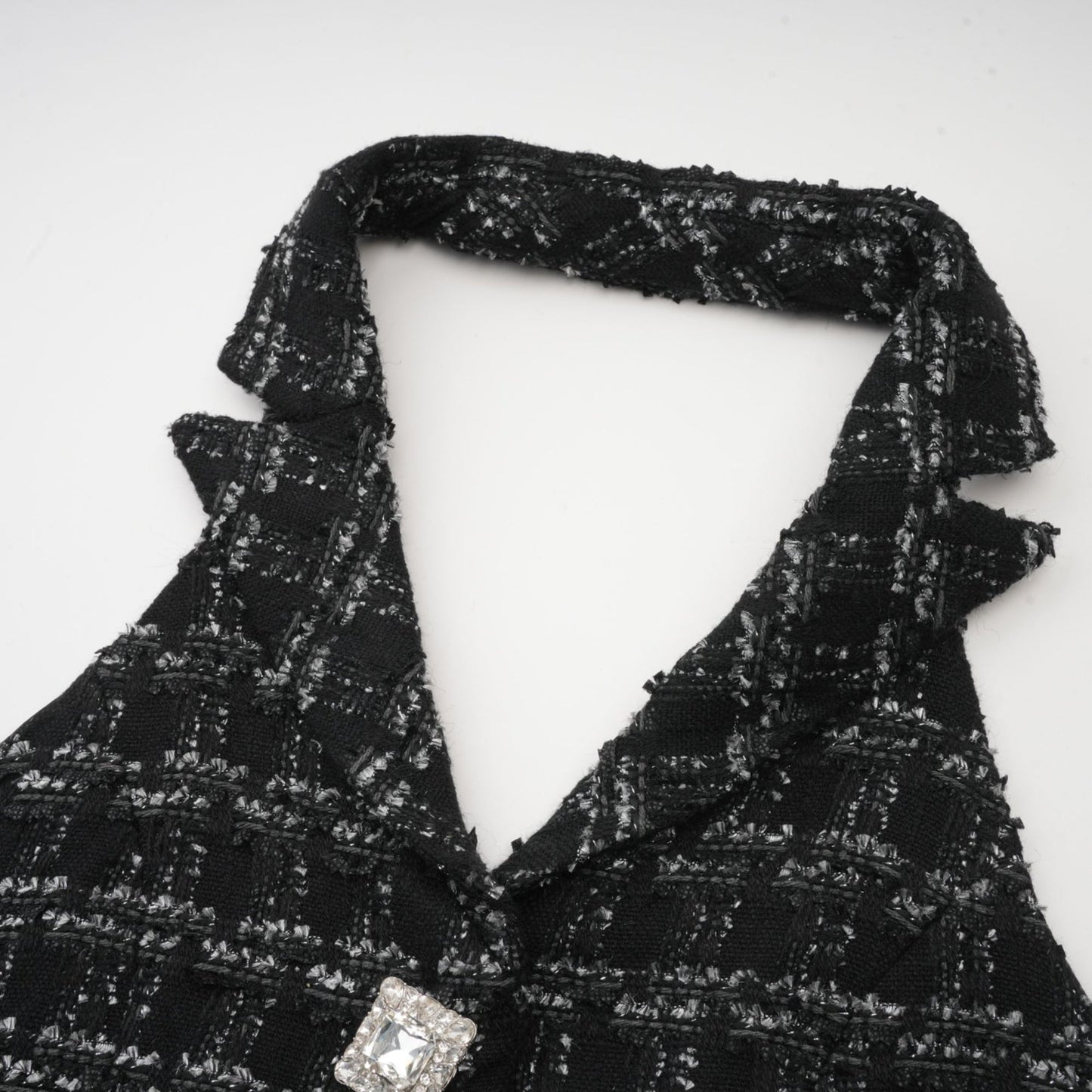 Woman wearing black and white checked tweed vest top and matching skirt set called Axelle