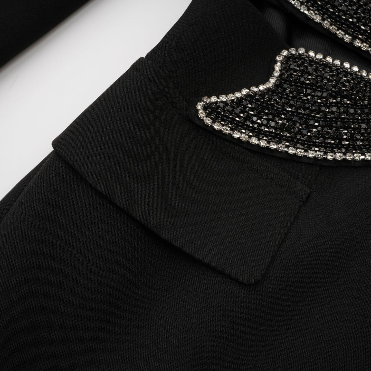Woman wearing black blazer with bowknot detail and cutout design