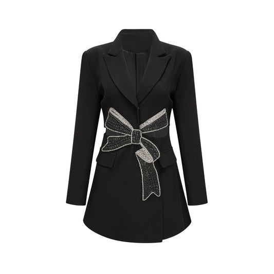 Woman wearing black blazer with bowknot detail and cutout design