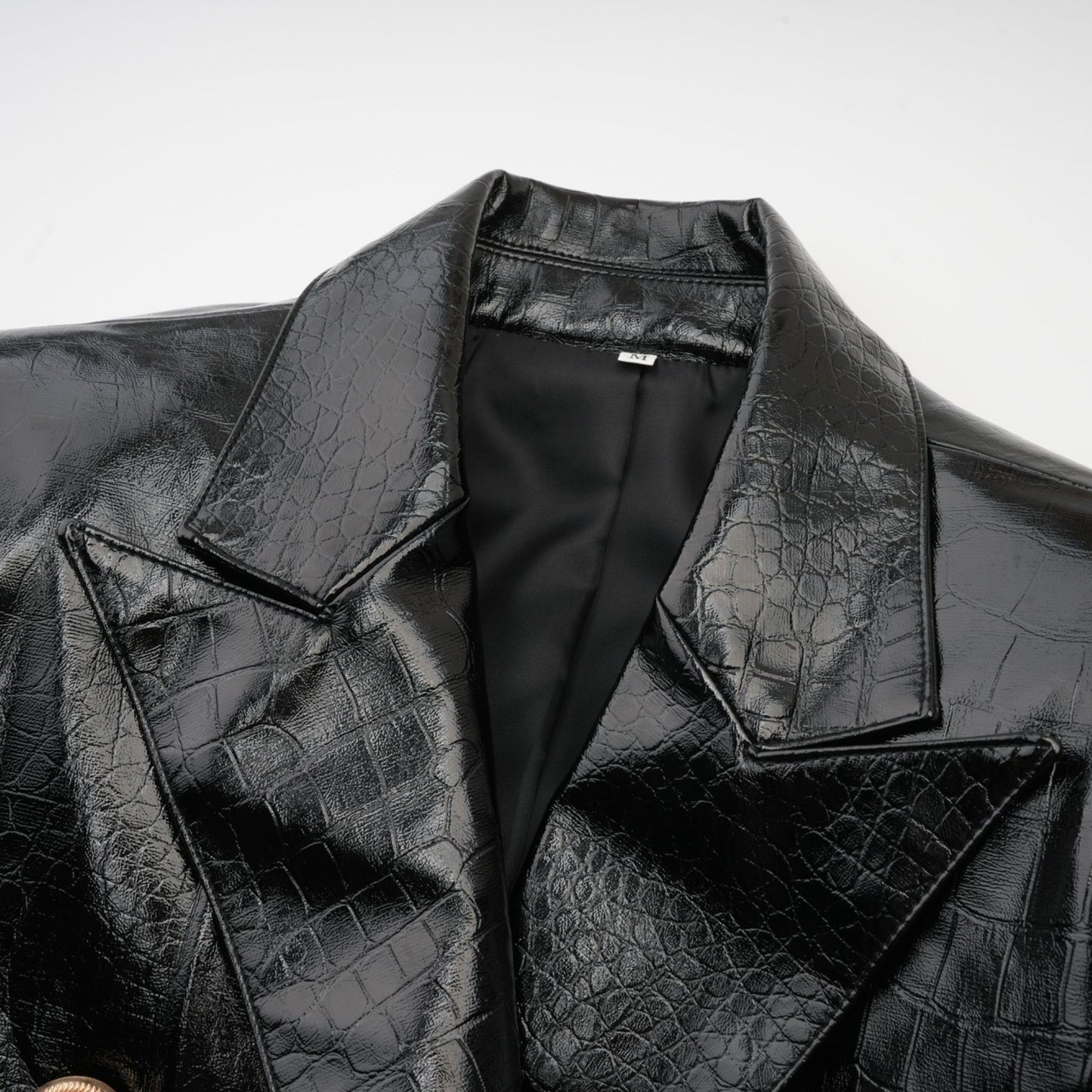 Woman wearing black leather jacket with cinched waist and zipper closure