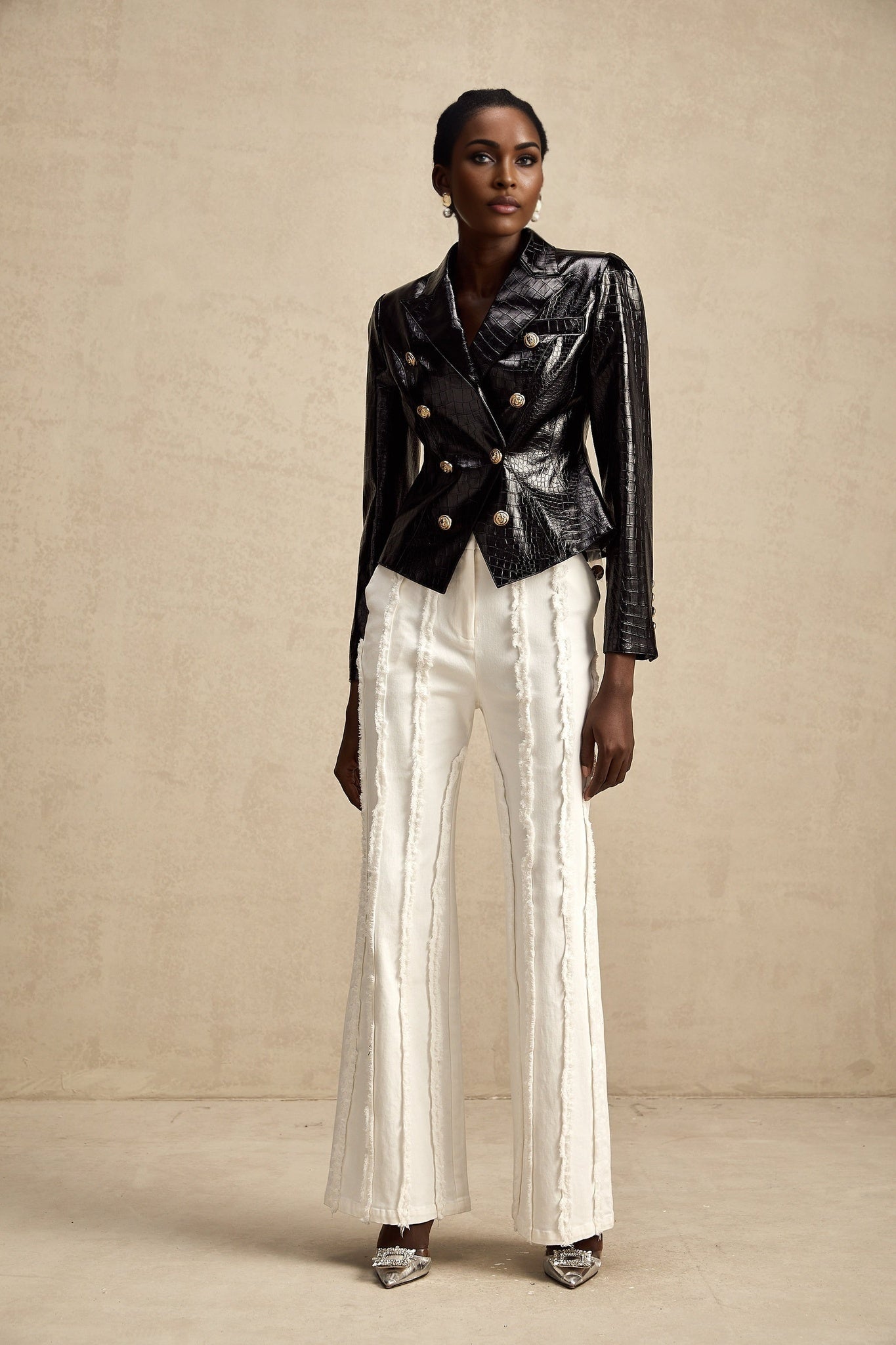 Woman wearing black leather jacket with cinched waist