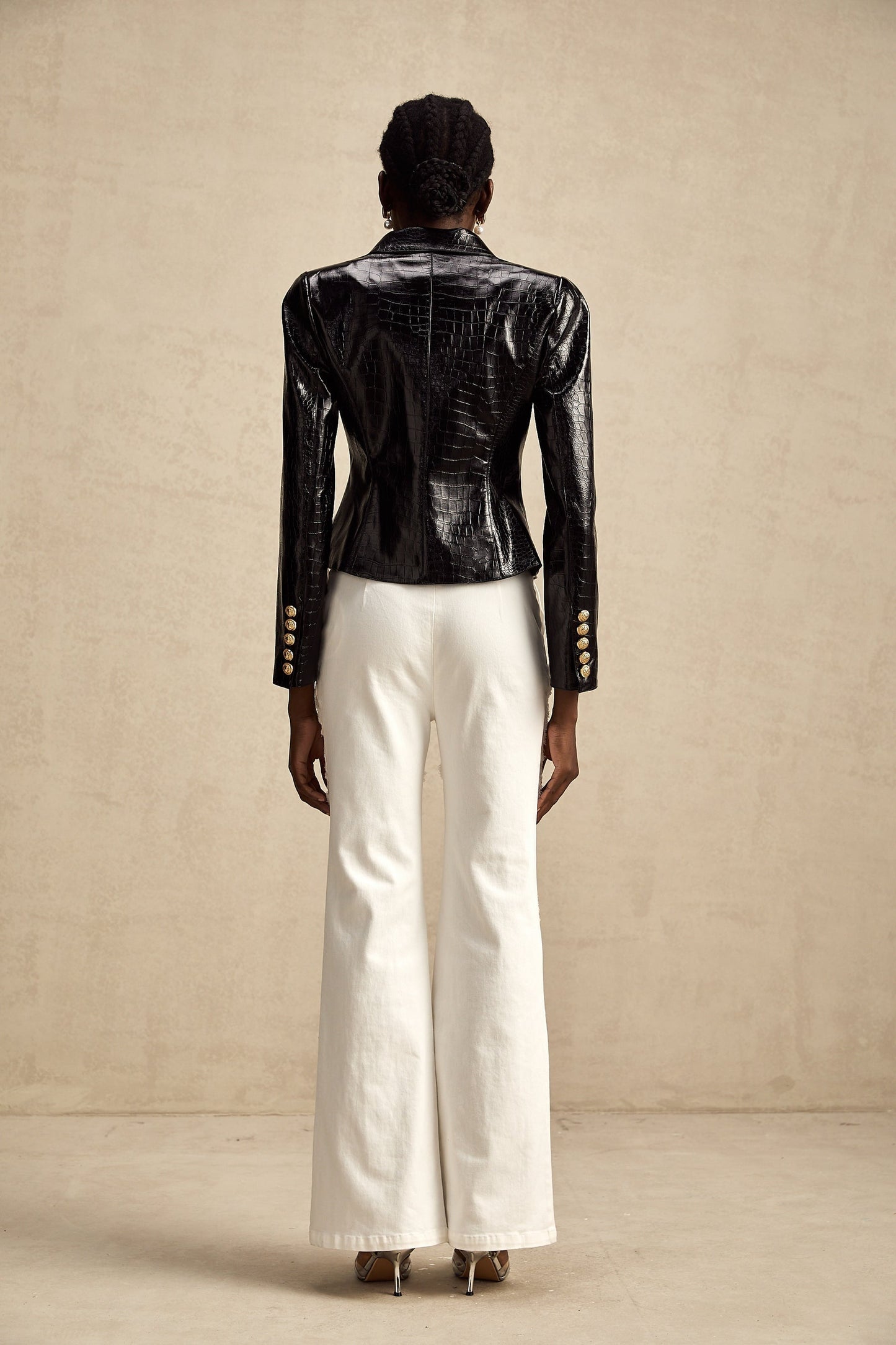 Woman wearing black leather jacket with cinched waist