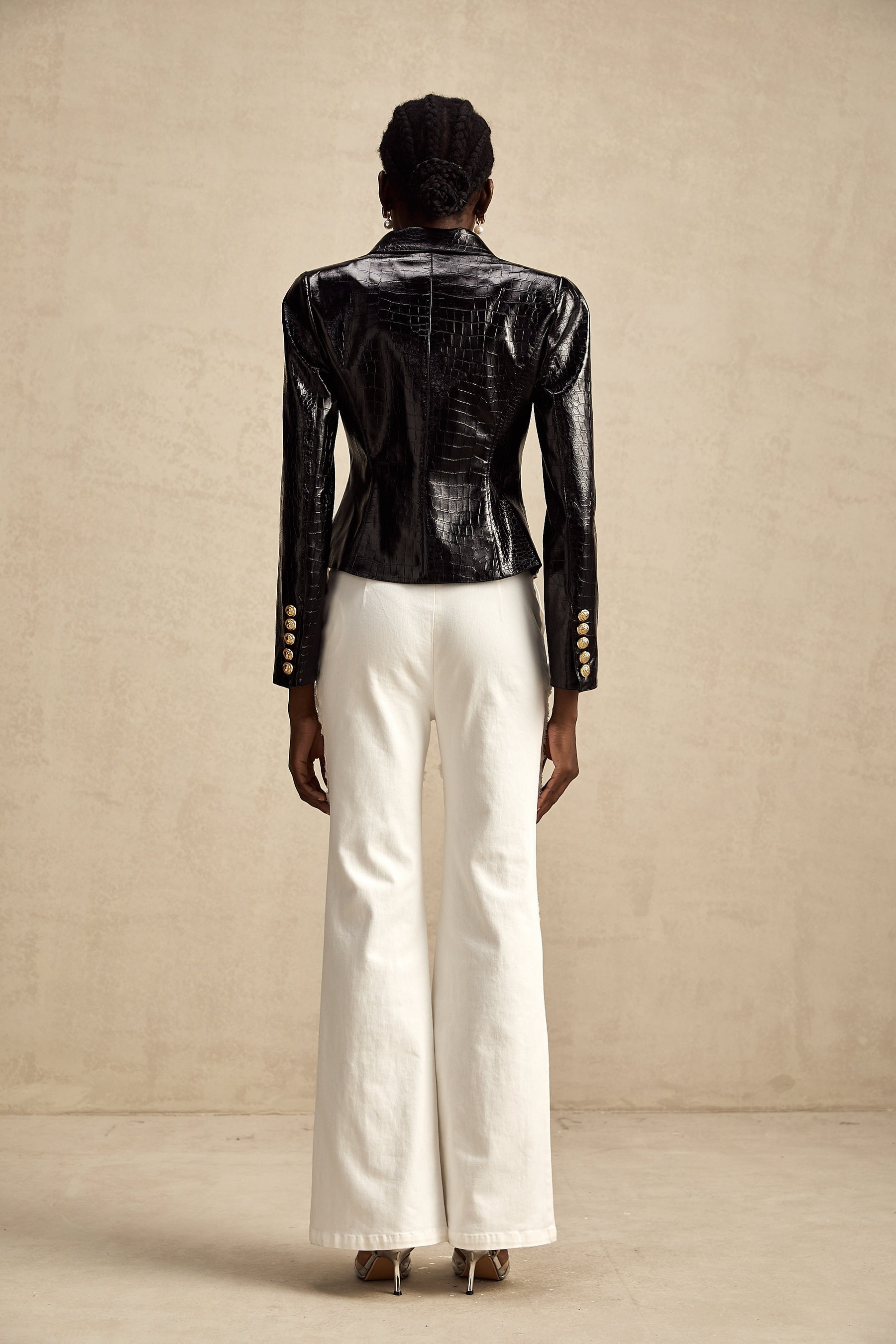 Woman wearing black leather jacket with cinched waist