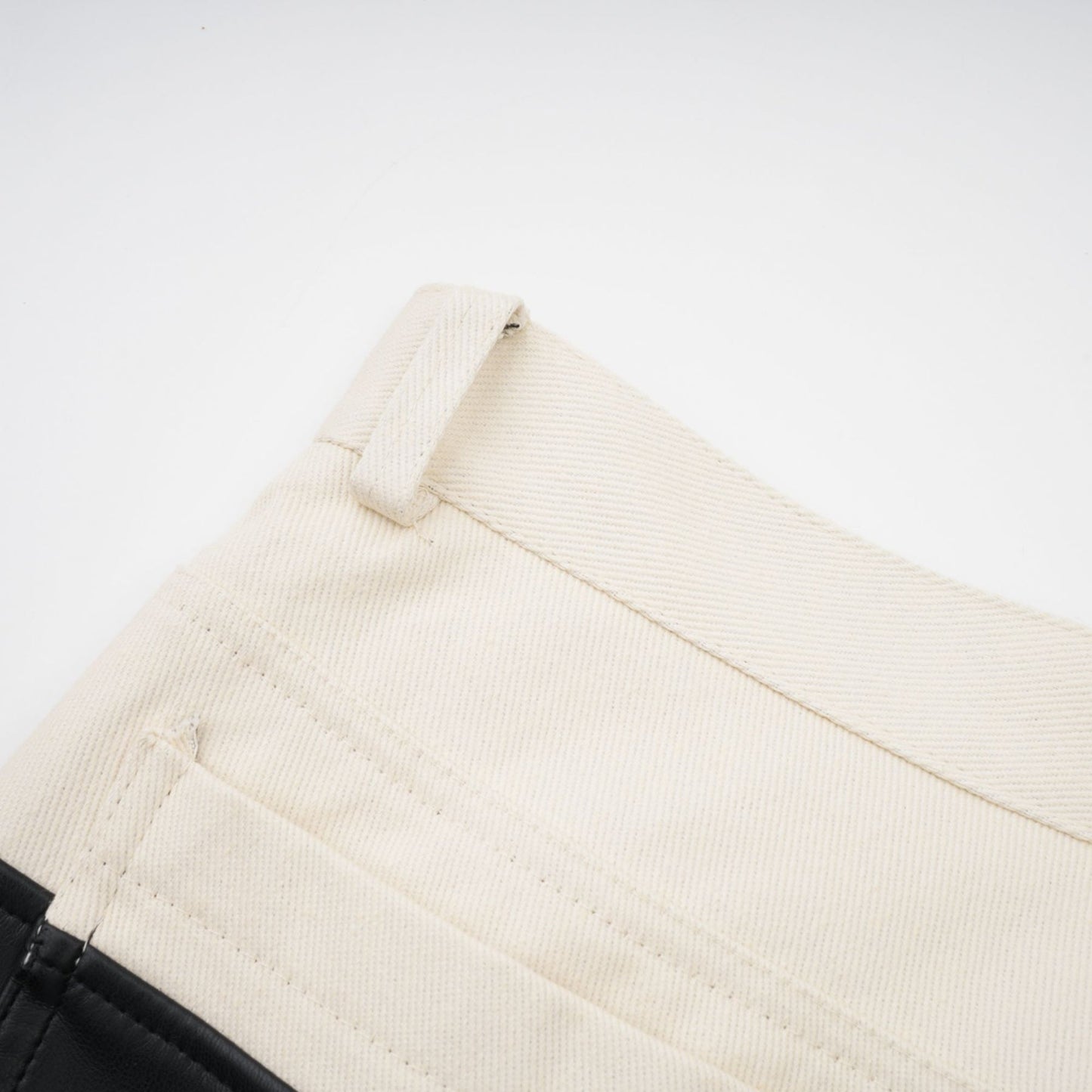 Woman wearing black leather trousers with white contrast stripes down the sides