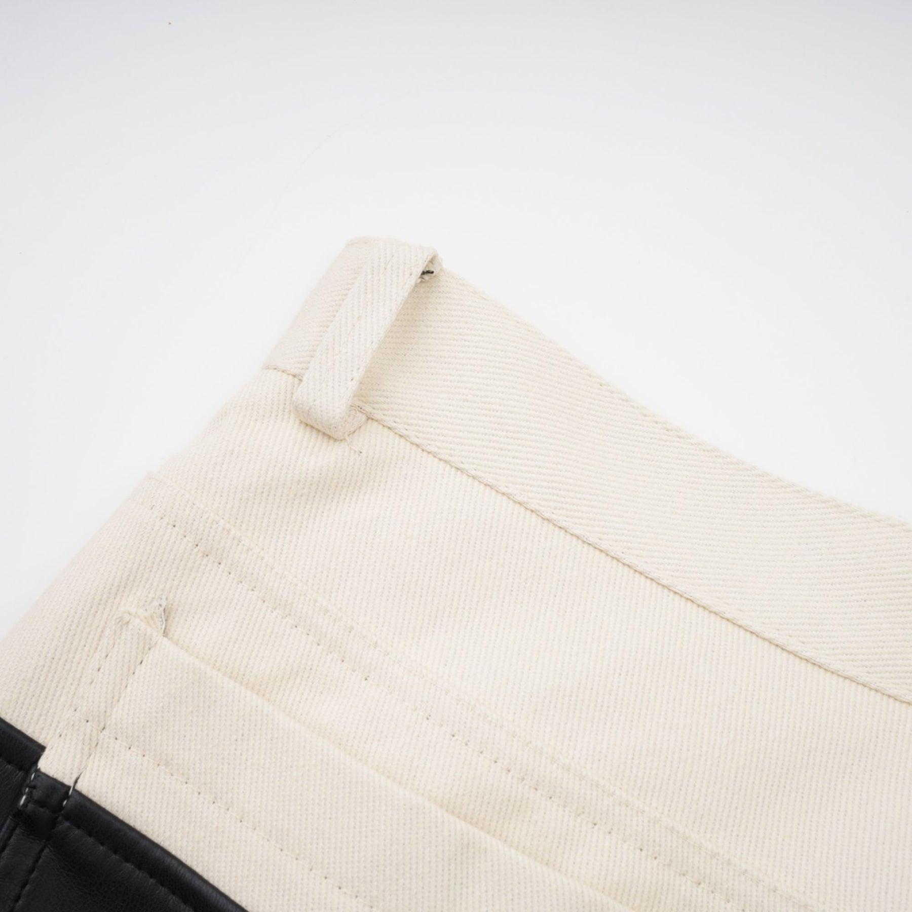 Woman wearing black leather trousers with white contrast stripes down the sides