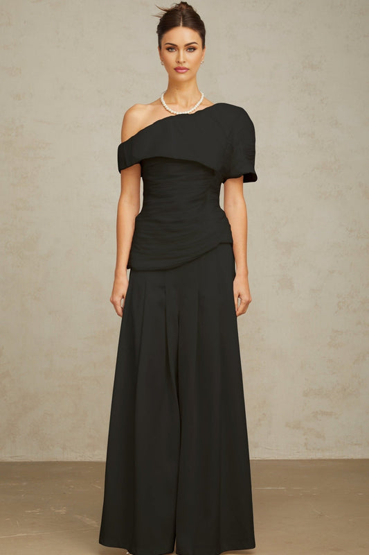 Woman wearing black matching set with creased top and trousers