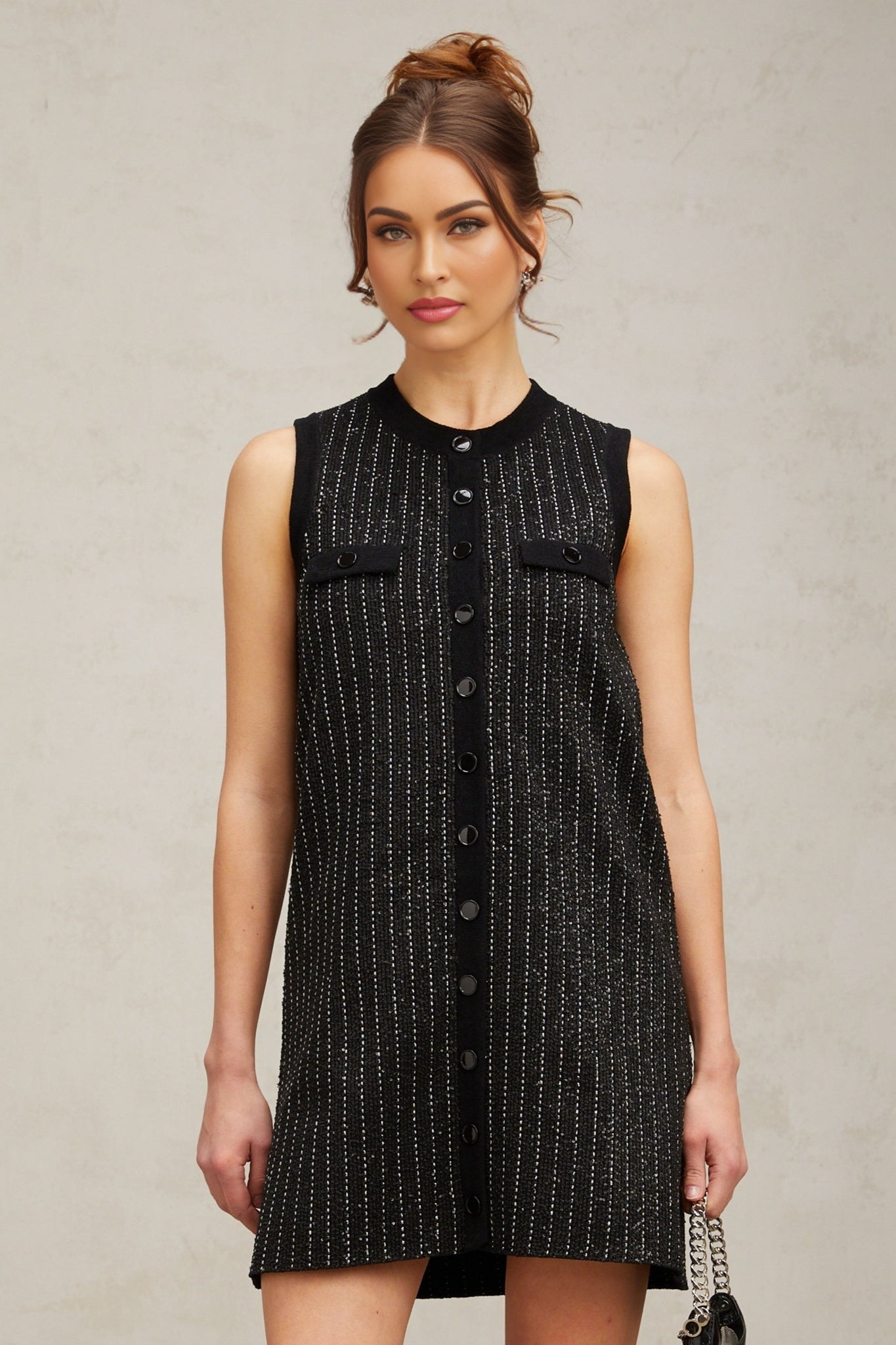 Woman wearing black mini dress with vertical sequin stripes knit fabric short length sleeveless design inspired by Zelda style