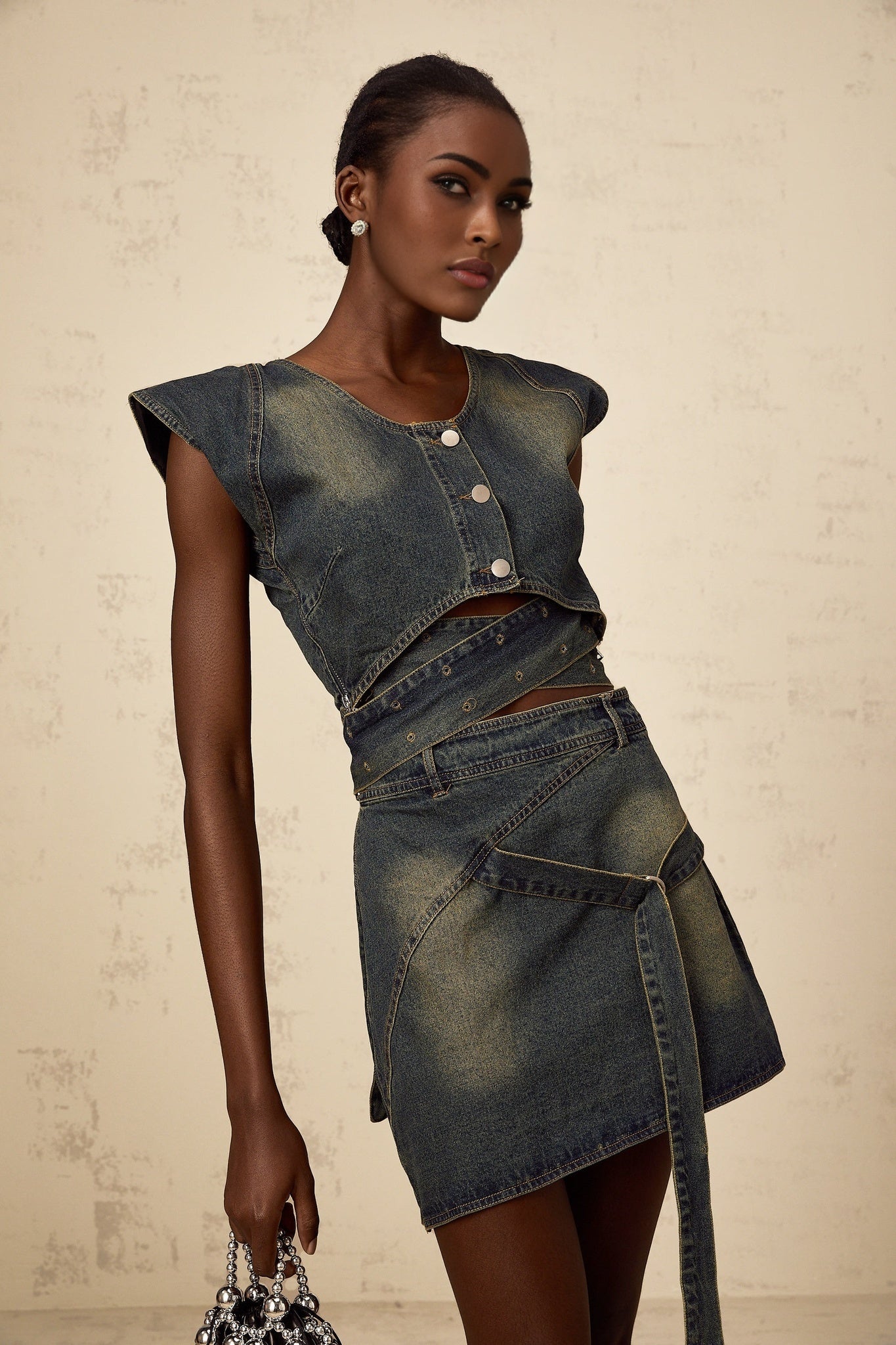 Woman wearing blue denim crossover top and matching skirt set