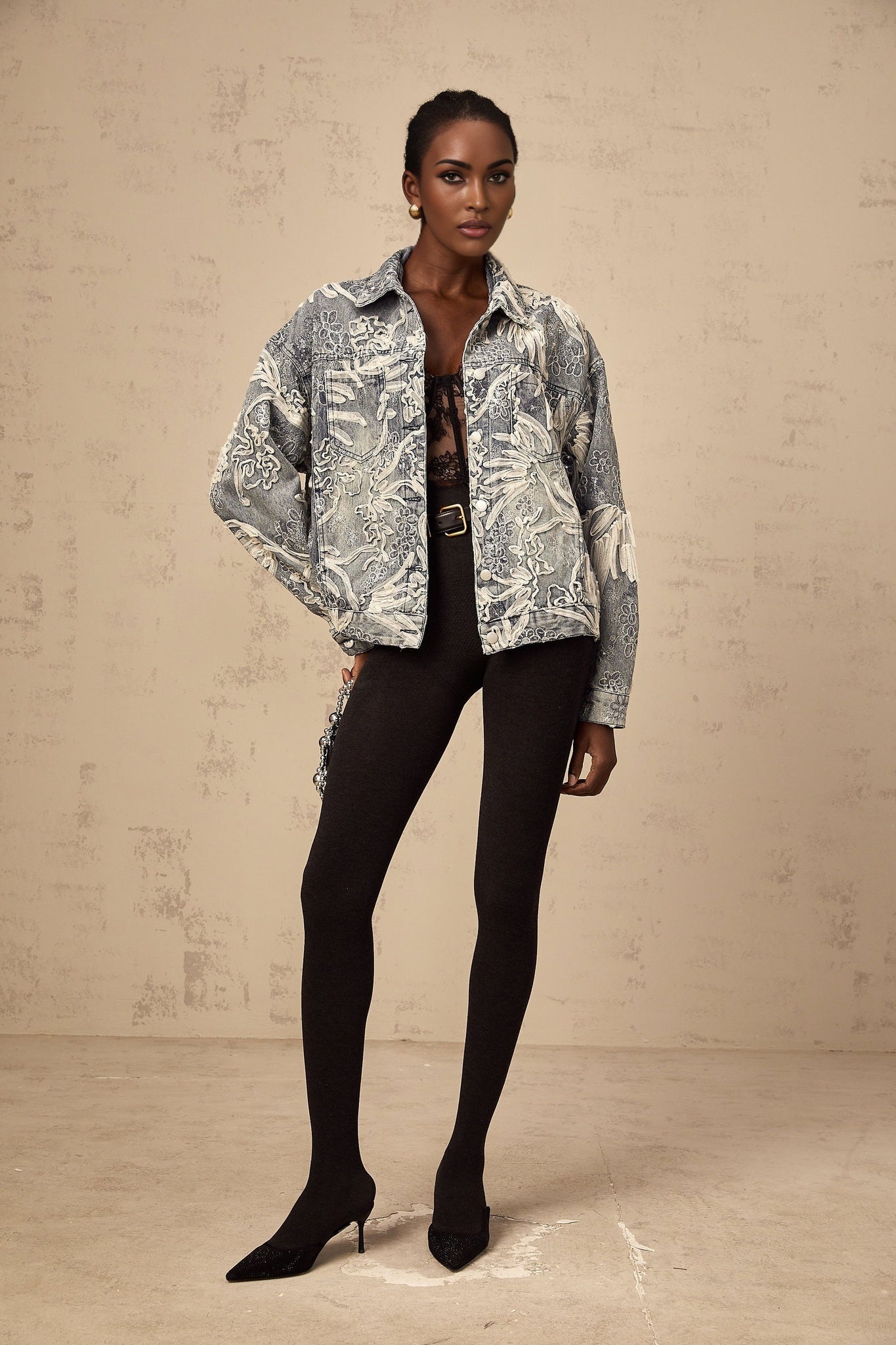 Woman wearing blue denim jacket with sequined flower embroidery design