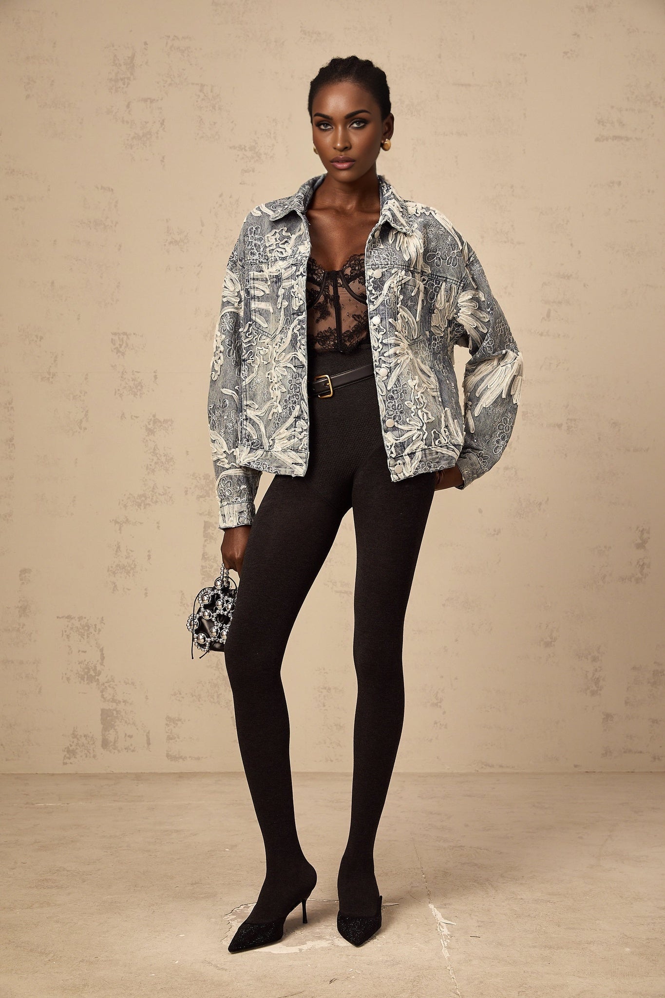 Woman wearing blue denim jacket with sequined flower embroidery design
