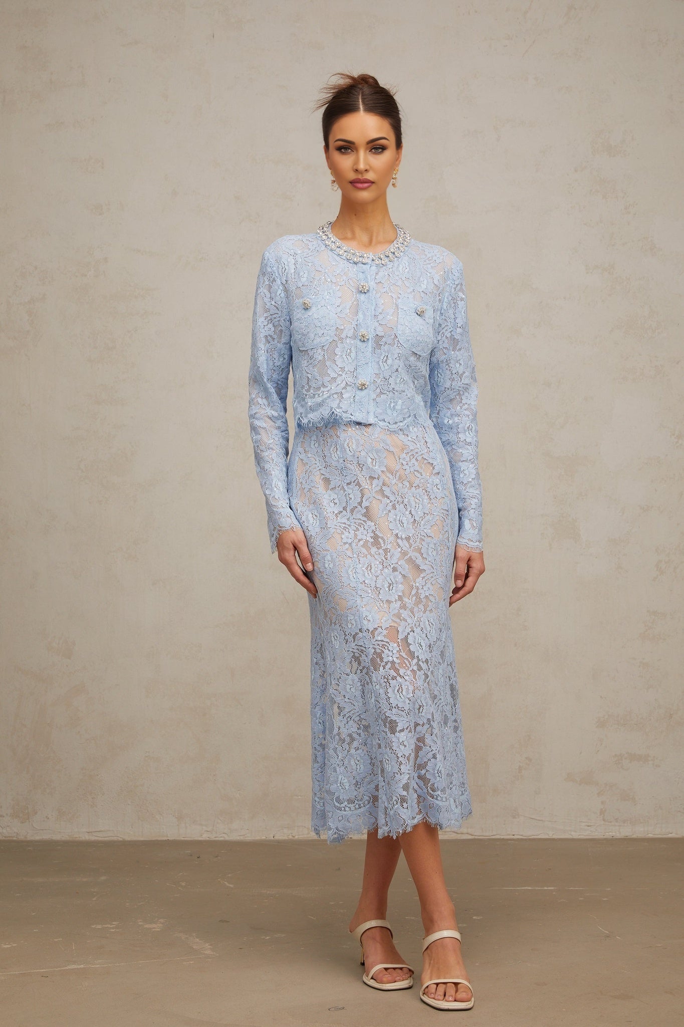 Woman wearing blue floral lace matching top and skirt set