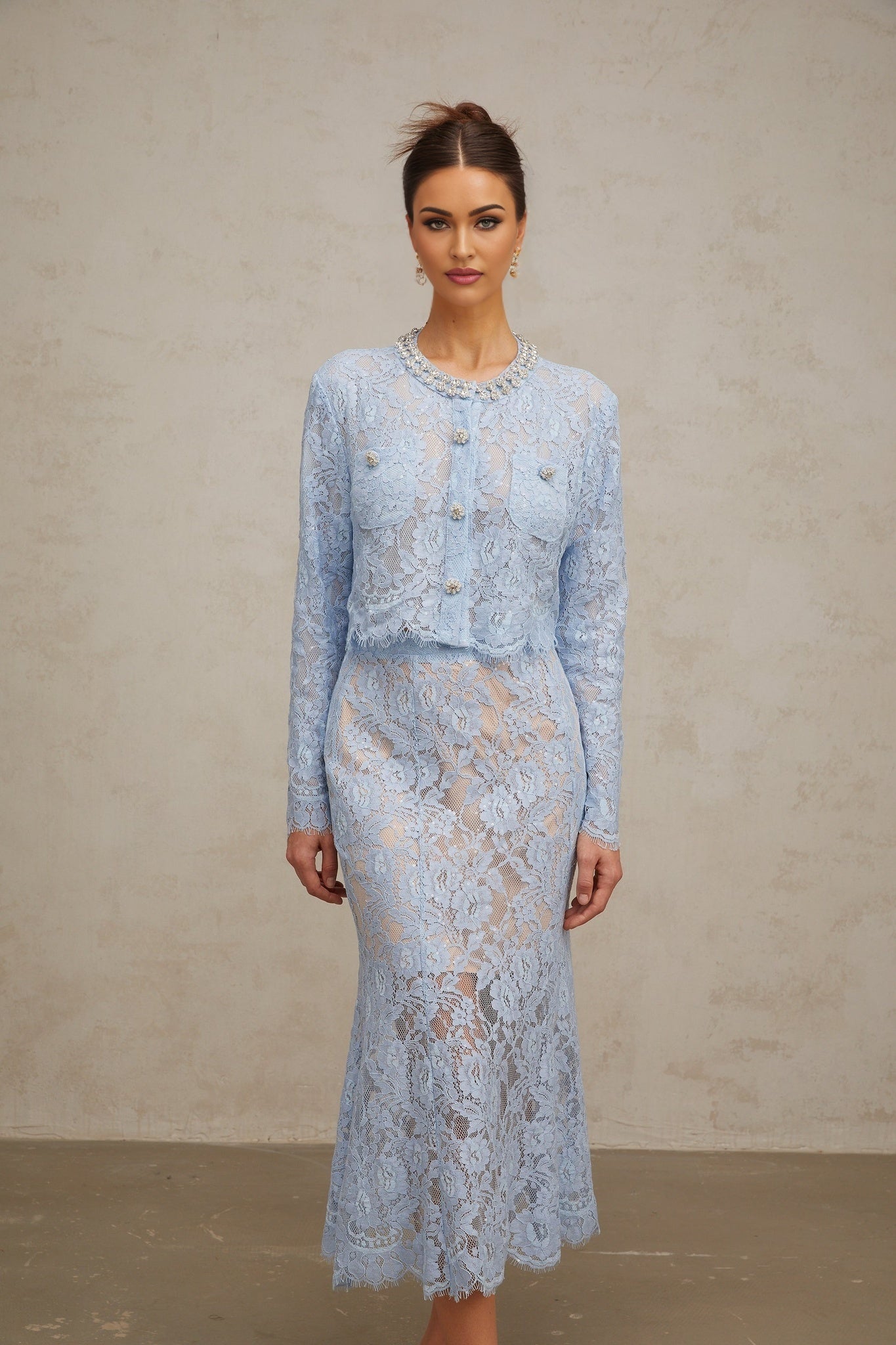 Woman wearing blue floral lace matching top and skirt set