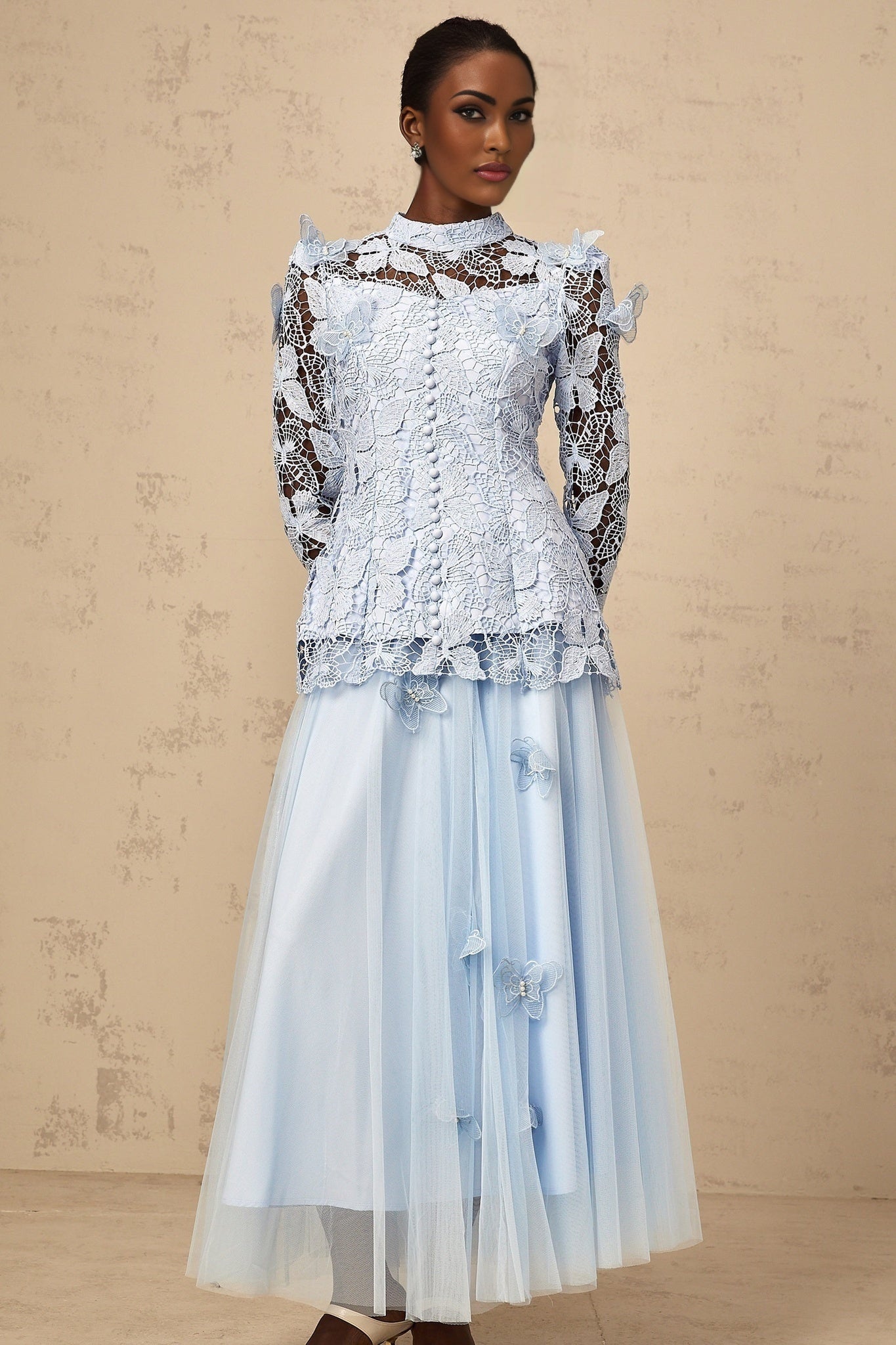 Woman wearing blue sequined lace matching top and skirt set shimmering two piece outfit with delicate lace details