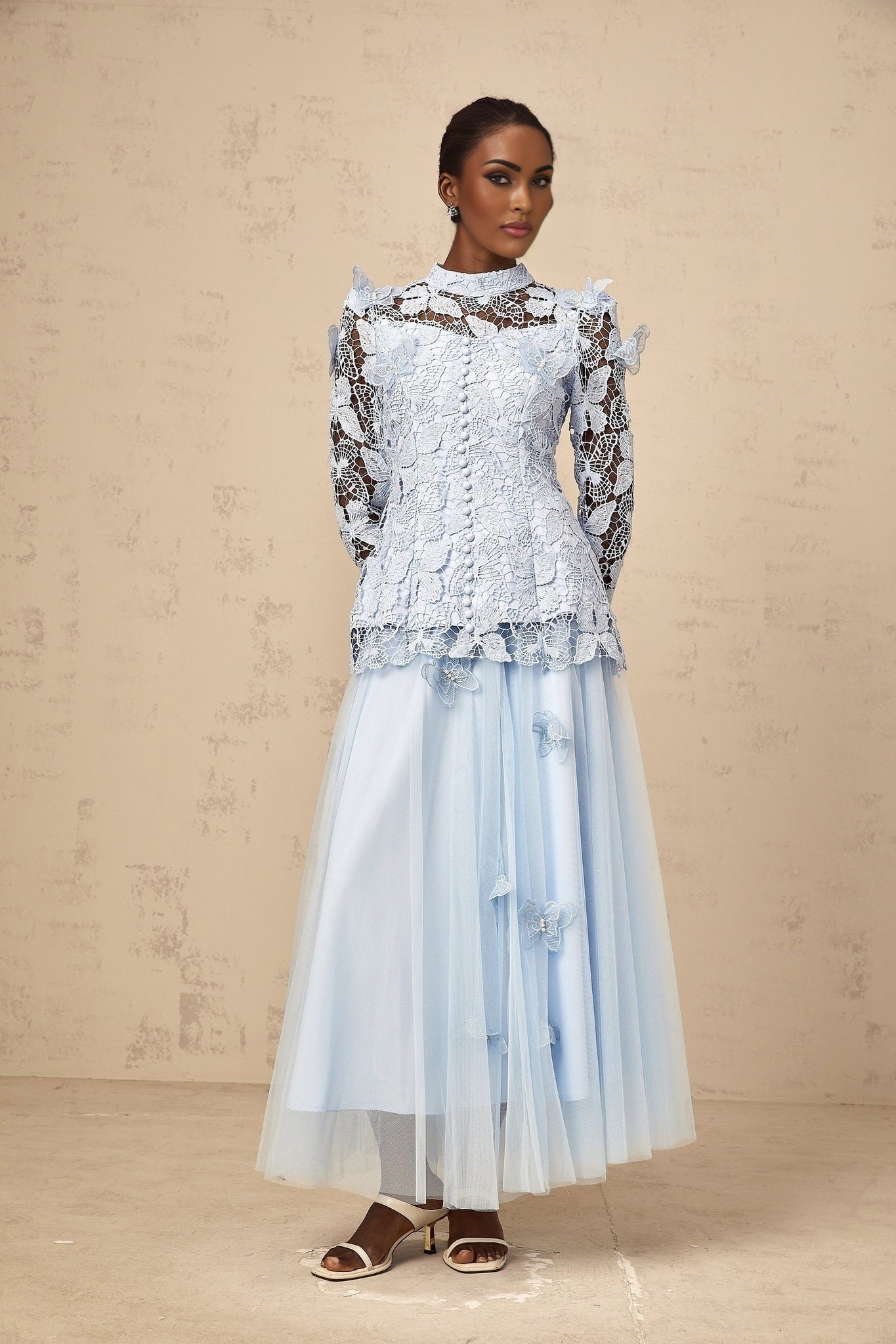 Woman wearing blue sequined lace top and matching skirt set Nicolette outfit shimmering two piece ensemble