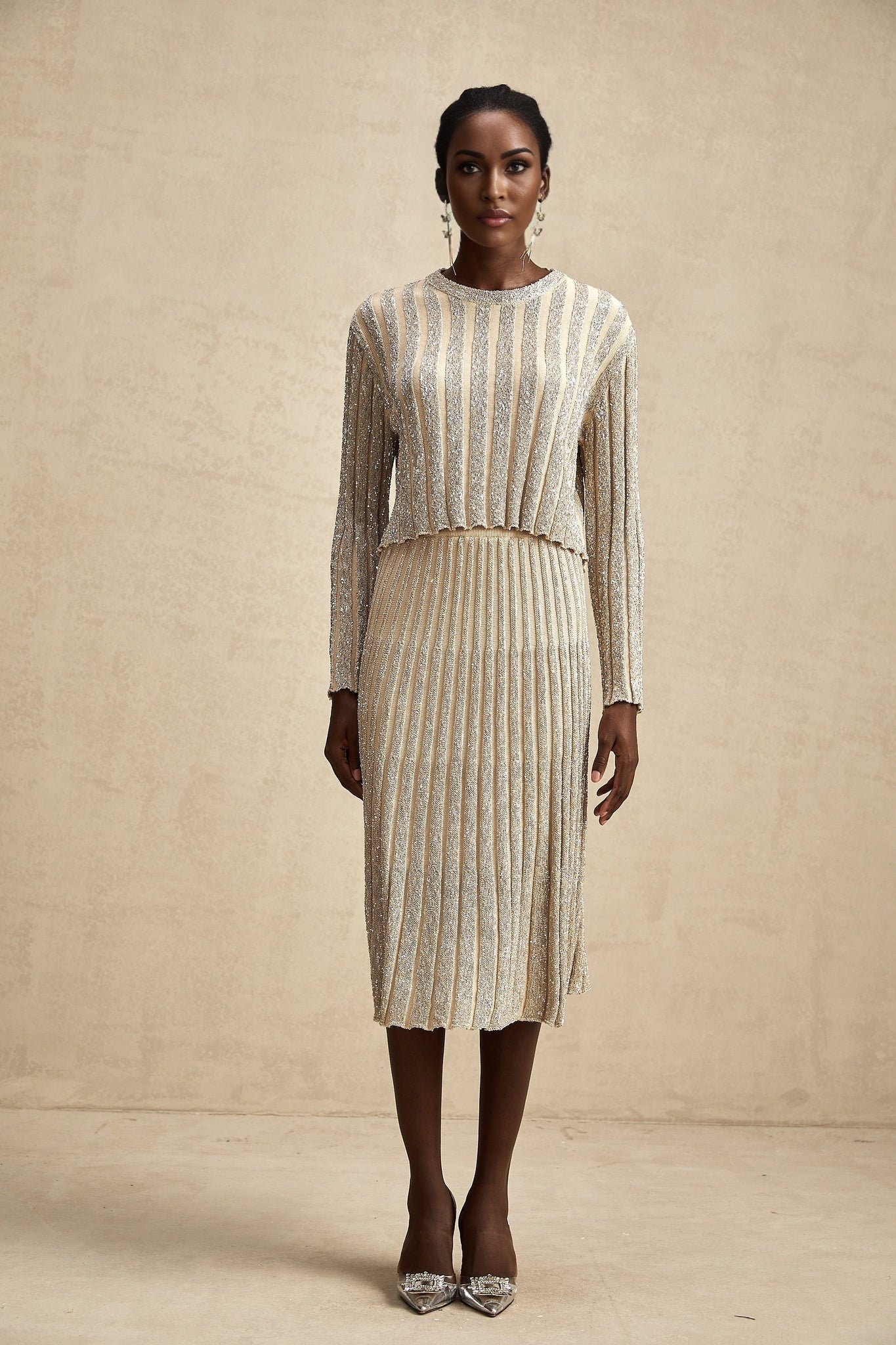 Woman wearing champagne colored striped knit top and matching skirt set Aurore design
