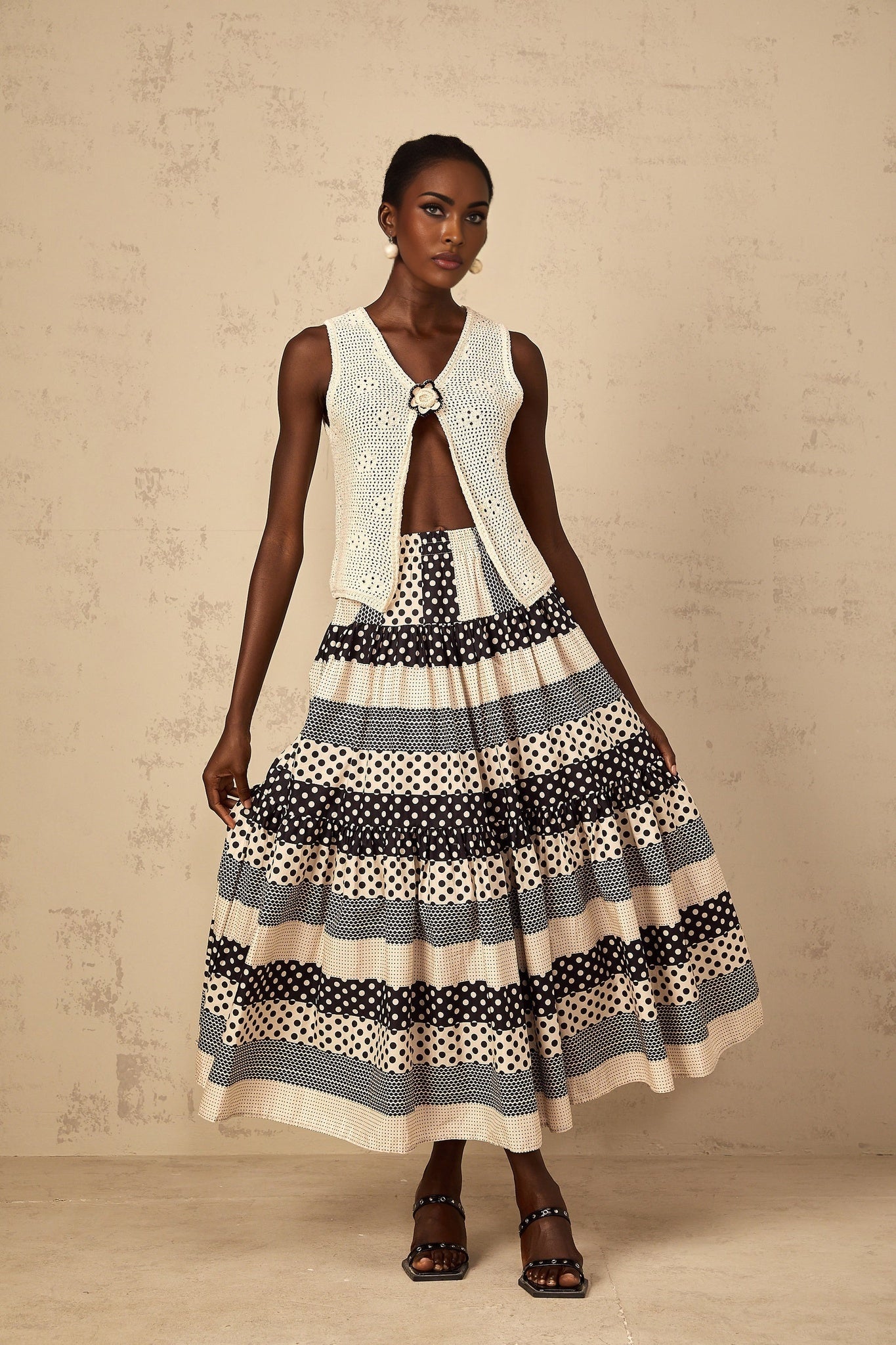 Woman wearing color block skirt with polka dot pattern and shirred waist in multiple colors