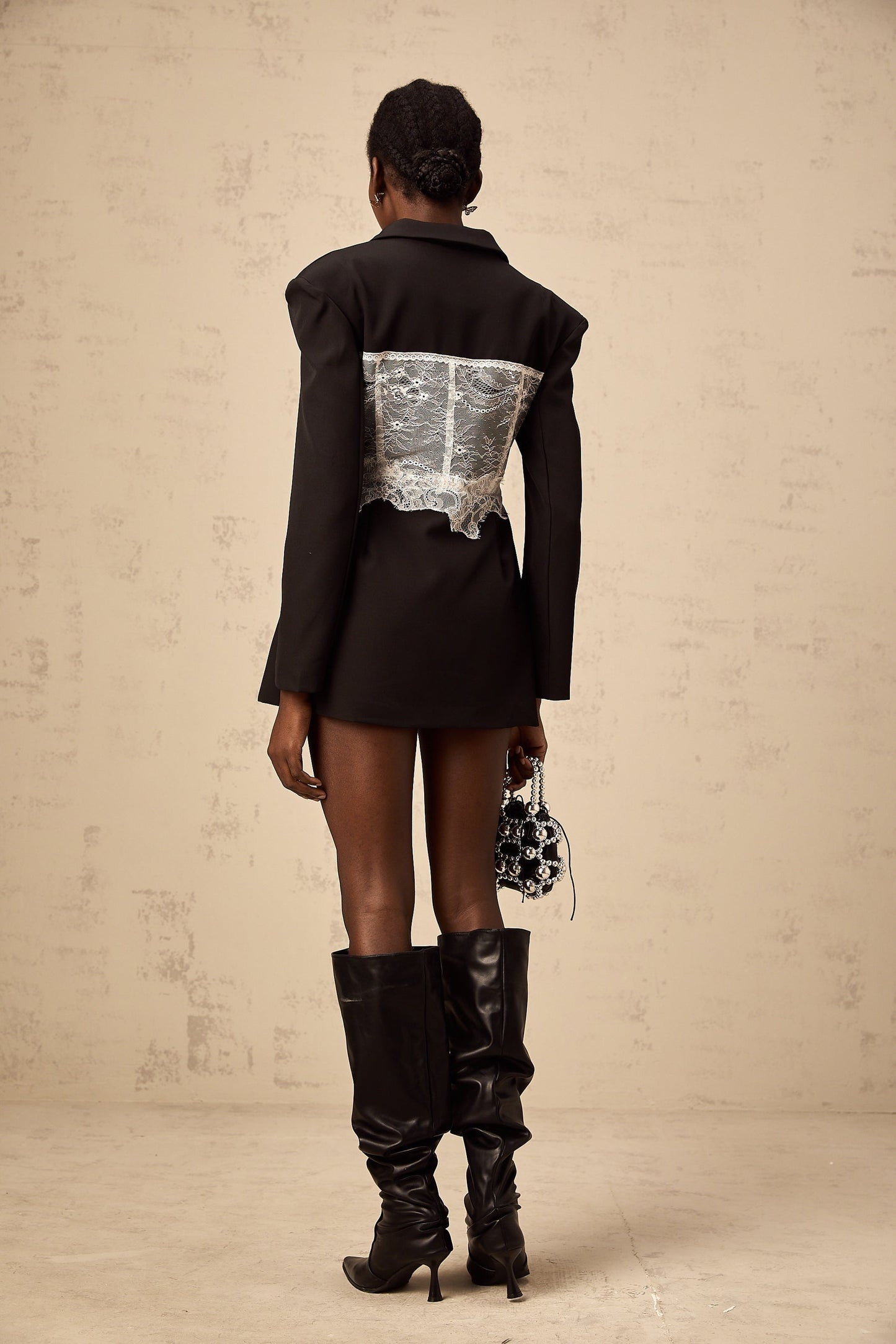 Woman wearing colorblocked blazer with lace panels in contrasting colors