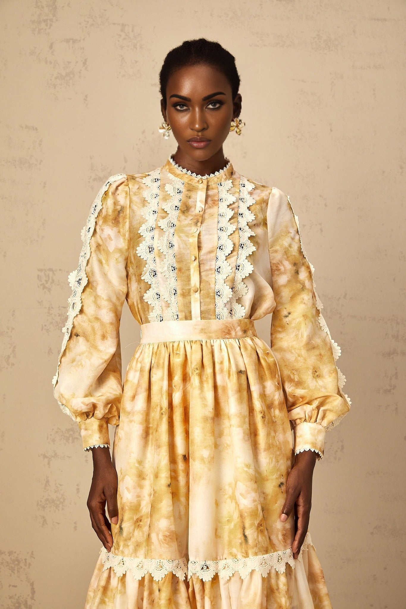 Woman wearing floral print blouse and matching skirt set with pink and white flower pattern on light background