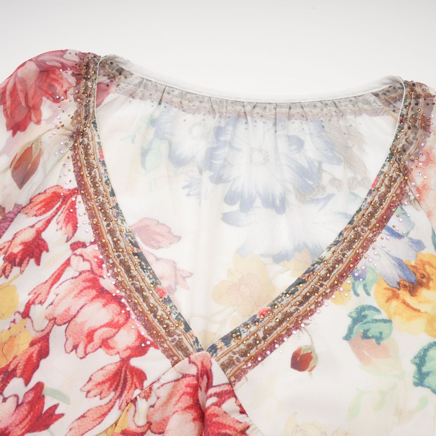 Woman wearing floral print blouse with V neckline named Yvonne