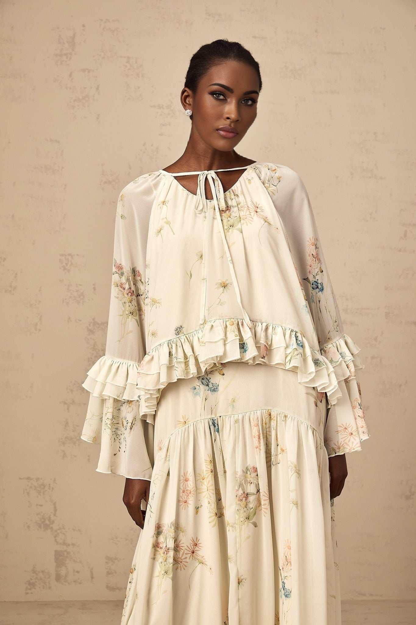 Woman wearing floral print matching blouse and dress set with ruffled details in Melissa style