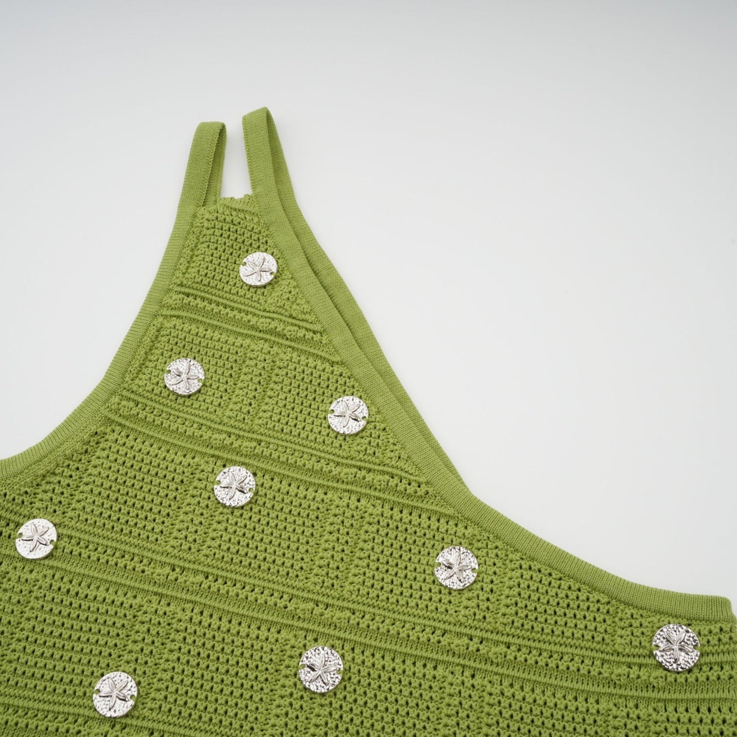 Woman wearing green knit top and skirt set with embellishments Annette matching outfit