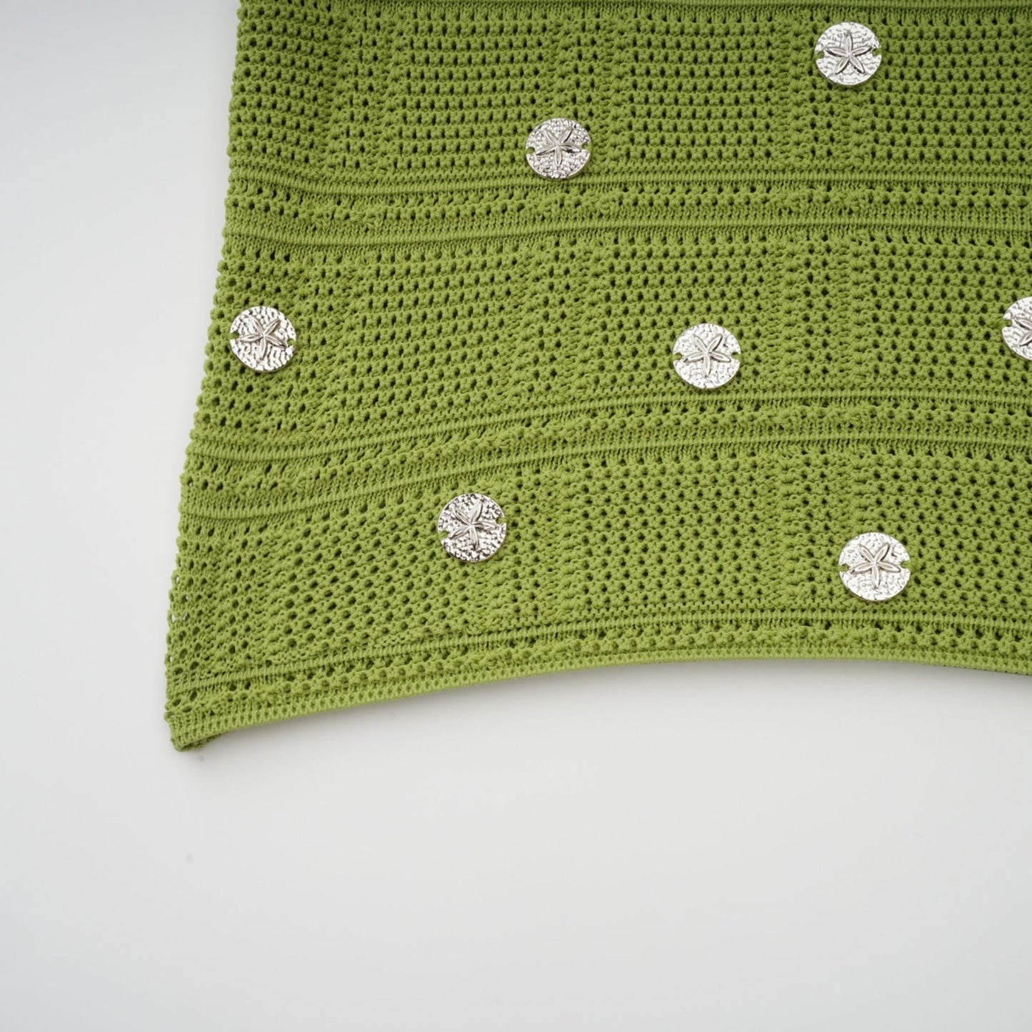 Woman wearing green knit top and skirt set with embellishments Annette matching outfit