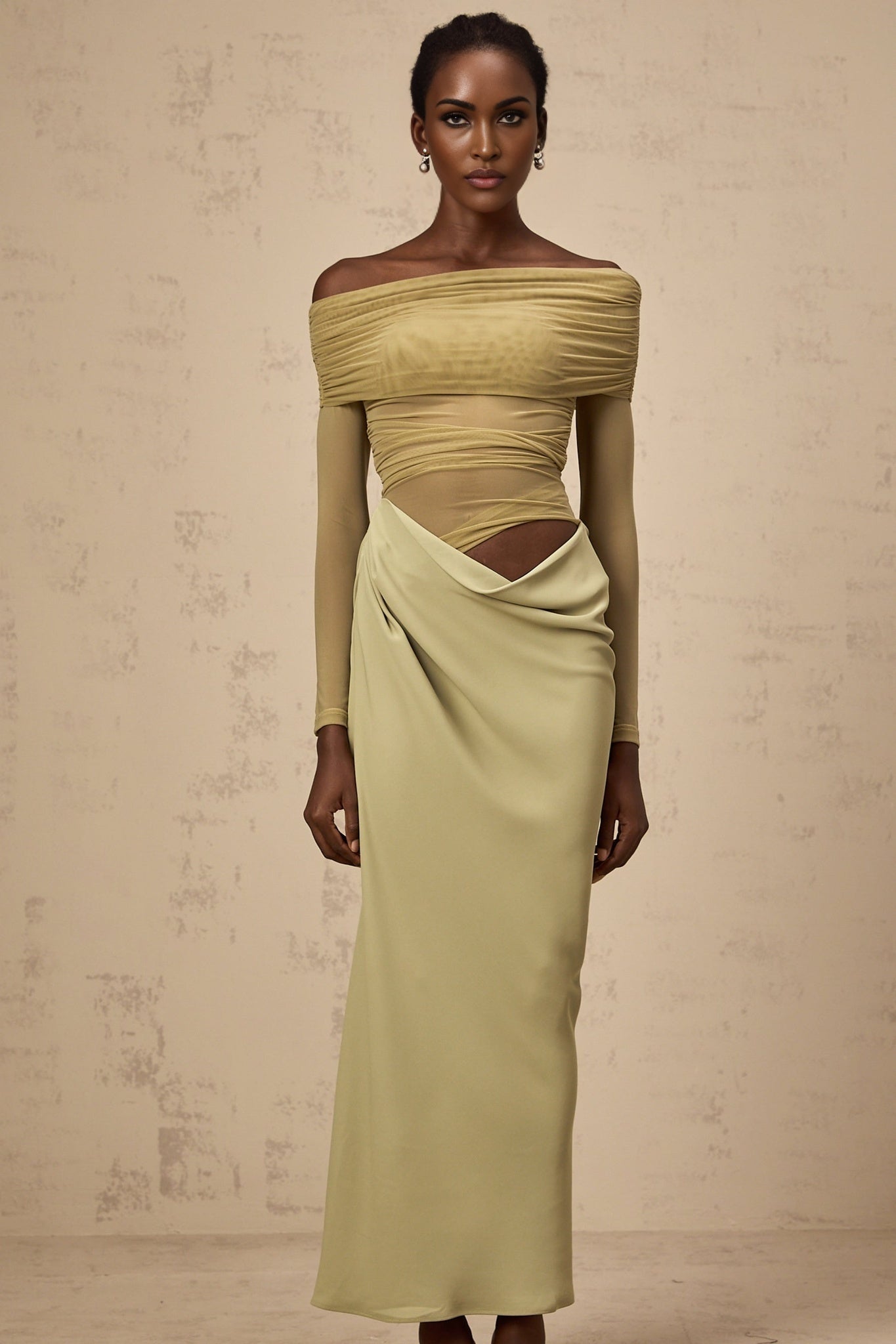 Woman wearing green offshoulder midi dress with semisheer fabric standing in relaxed pose