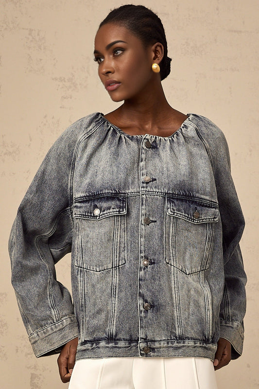 Woman wearing light blue collarless denim jacket with front pockets and button closure
