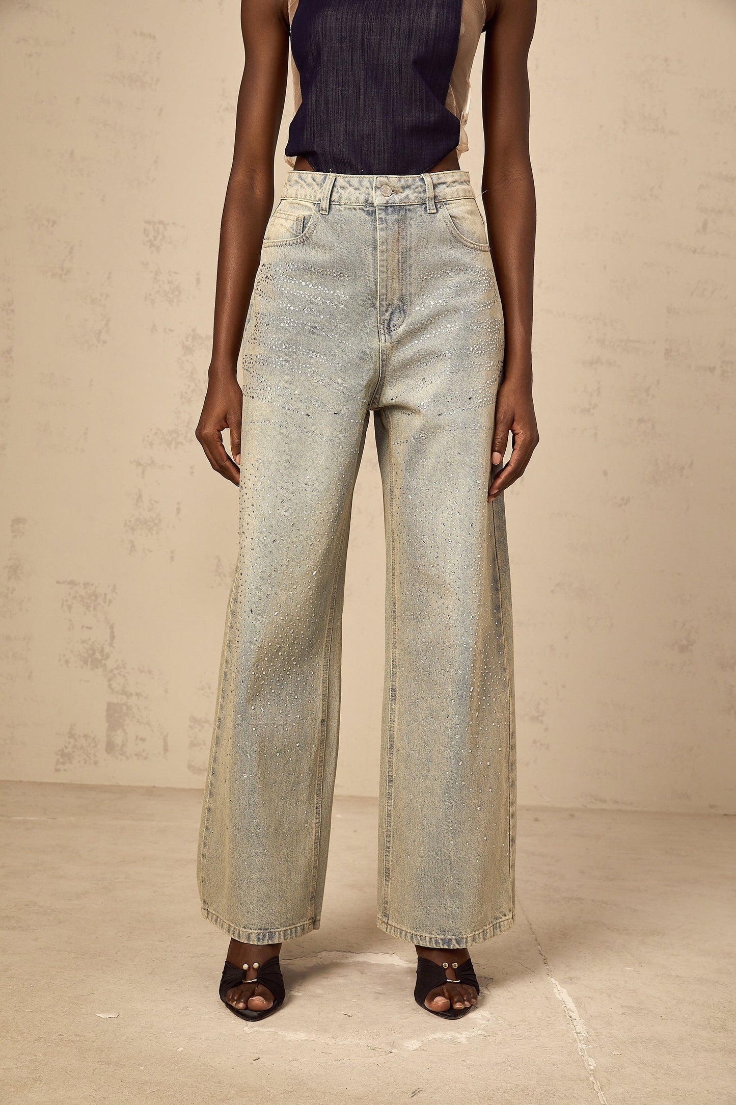 Woman wearing light blue denim jeans with rhinestone embellishments