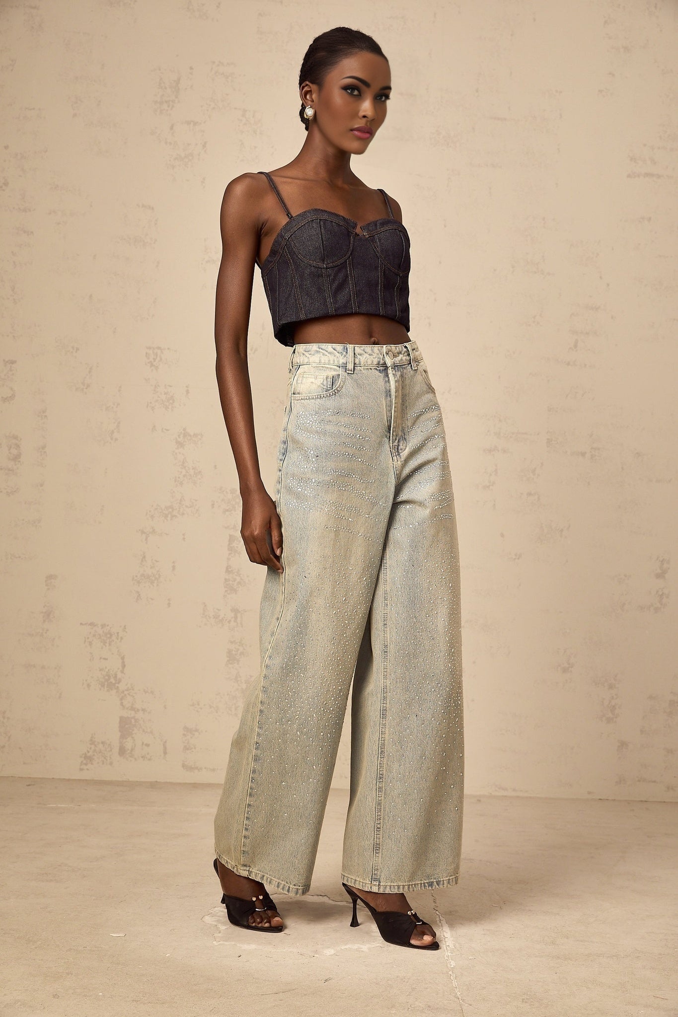 Woman wearing light blue denim jeans with rhinestone embellishments