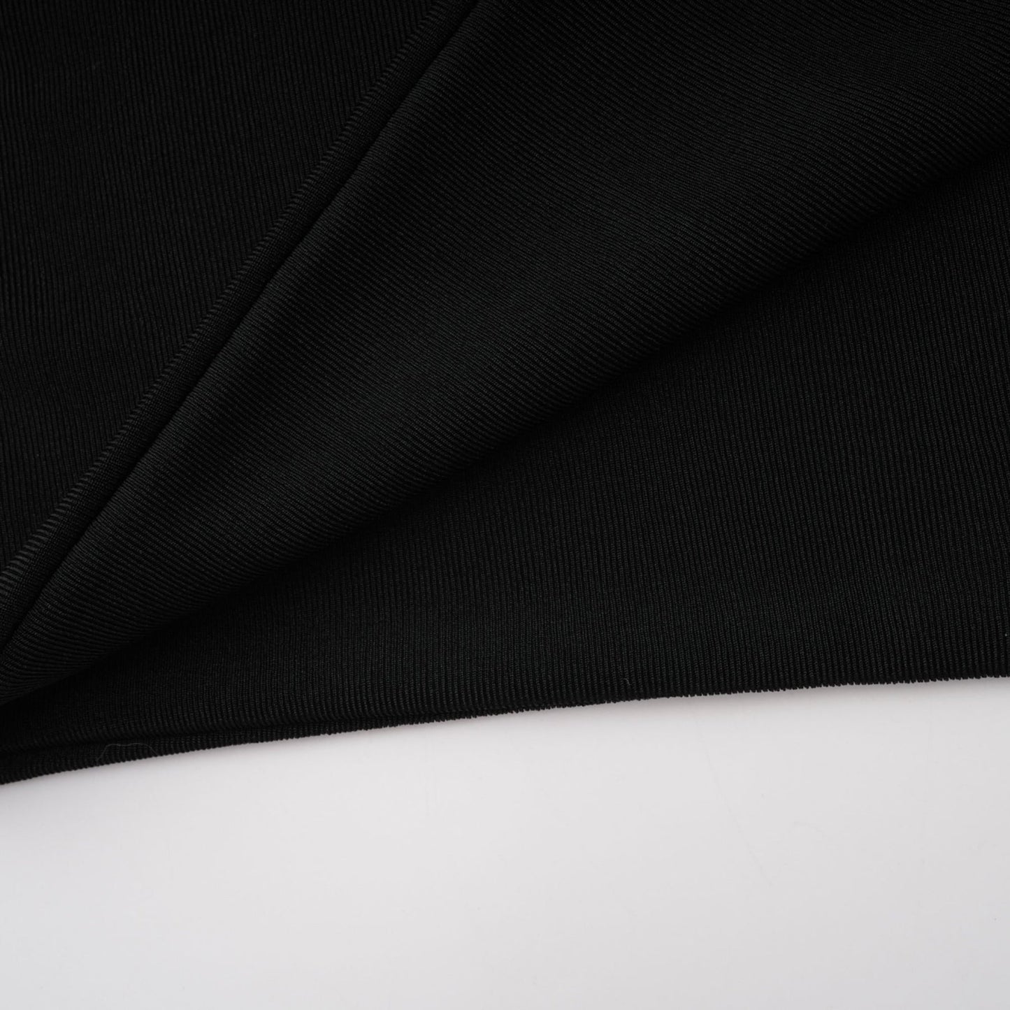 Woman wearing long black hooded dress with floral applique details