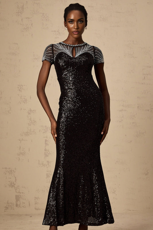 Woman wearing long black sequined maxi dress with cut out details