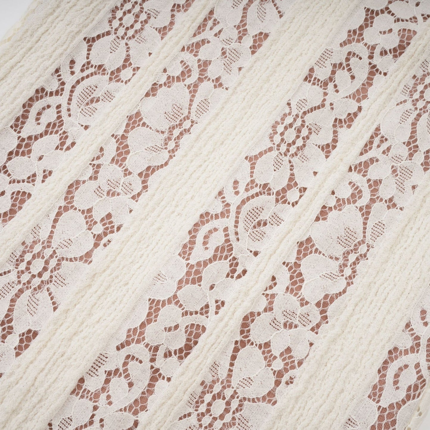 Woman wearing long neutral floral lace maxi dress with train design