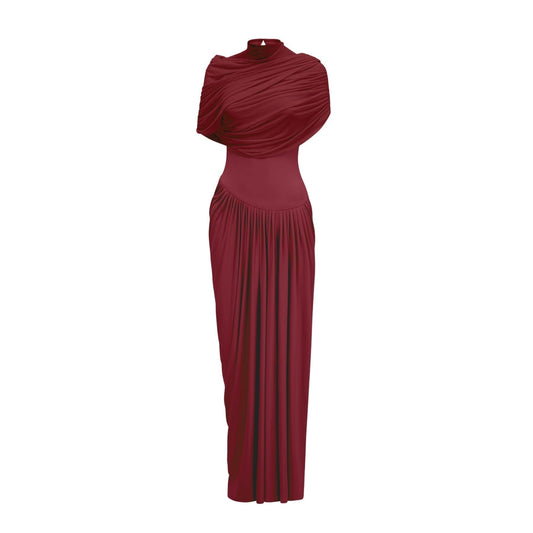 Woman wearing long red asymmetric pleated maxi dress with flowing skirt