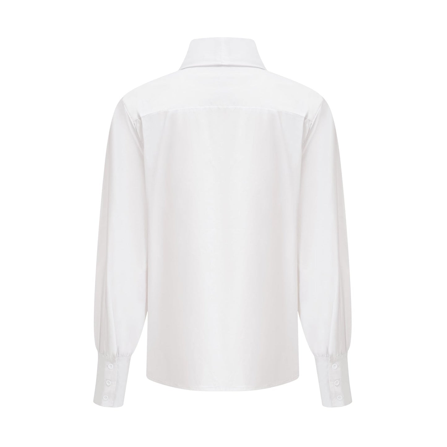Woman wearing loose fitting white cotton button up shirt with tie detail at waist