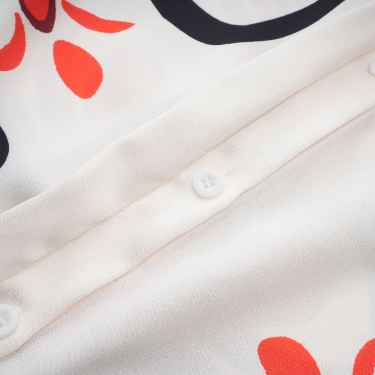 Woman wearing matching floral print shirt and trousers set in vibrant colors Standing pose showcasing full outfit