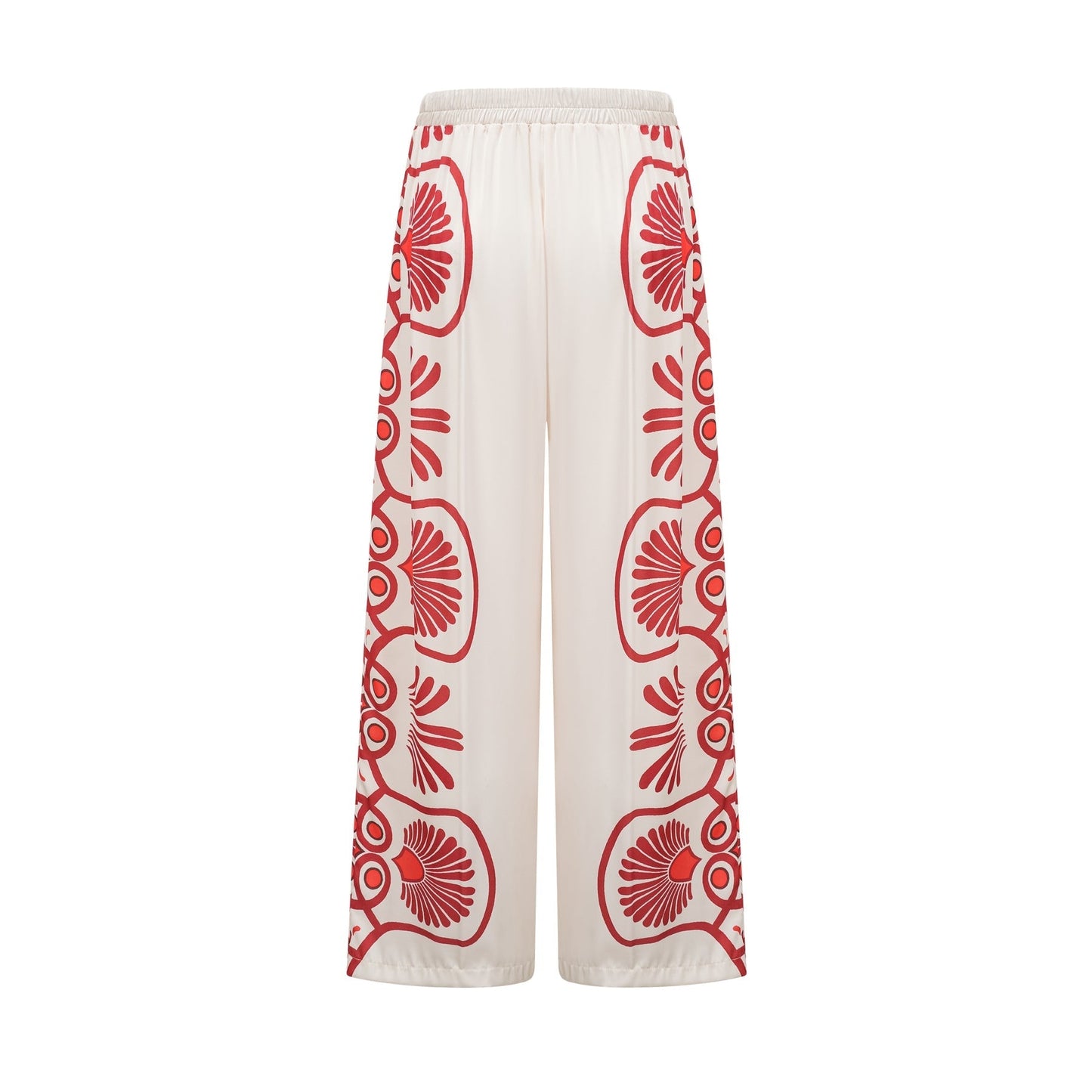 Woman wearing matching floral print shirt and trousers set in vibrant colors with Amaranta design