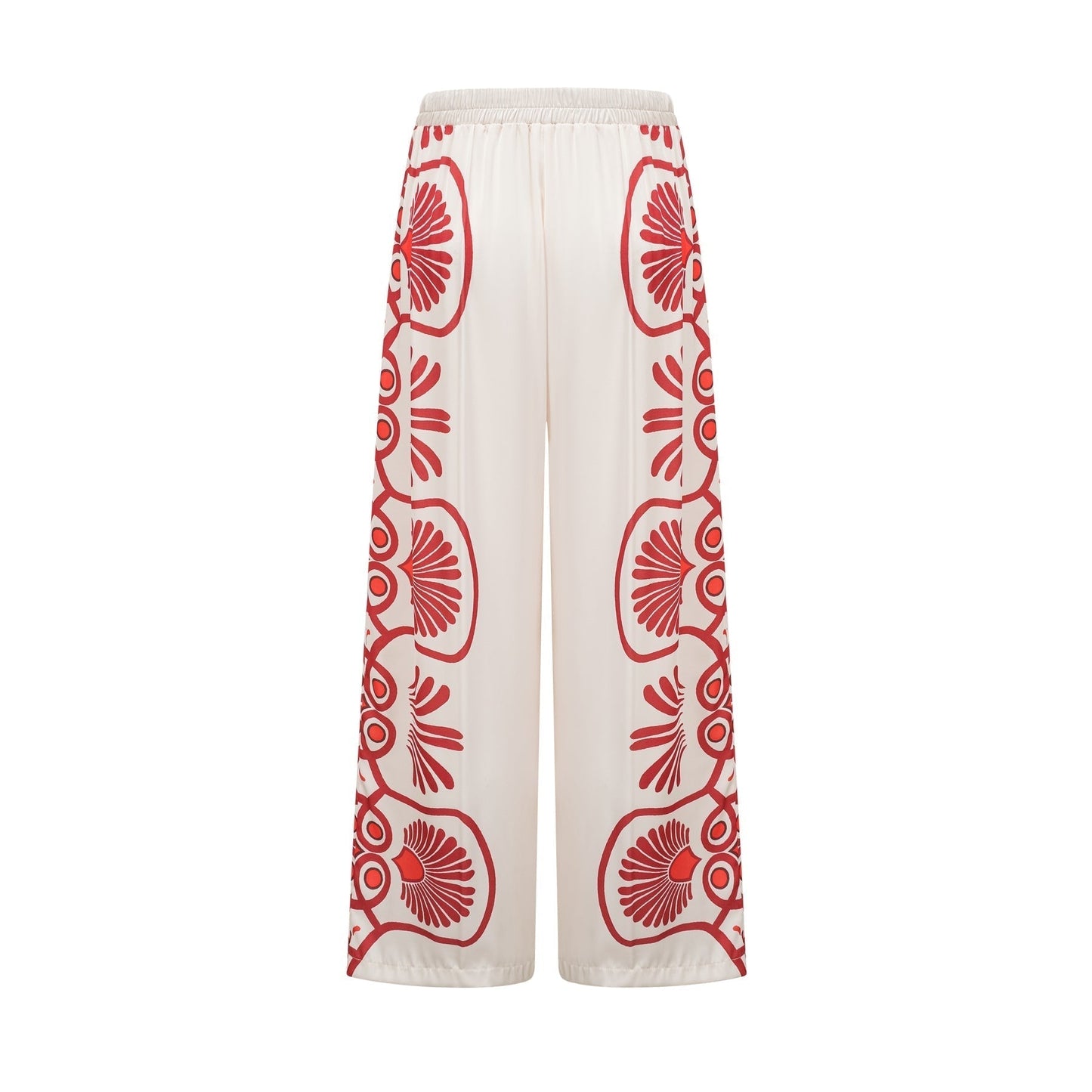 Woman wearing matching floral print shirt and trousers set in vibrant colors with Amaranta design